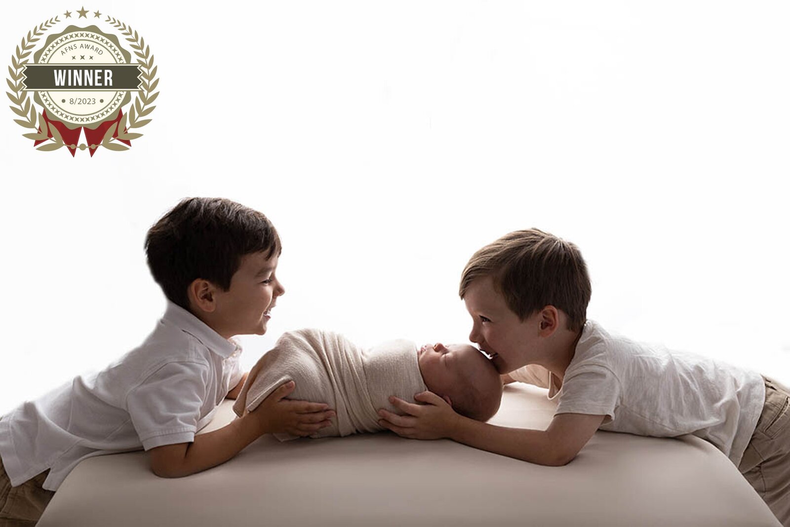 Three brothers smile together for their family session in Murrysville studio.