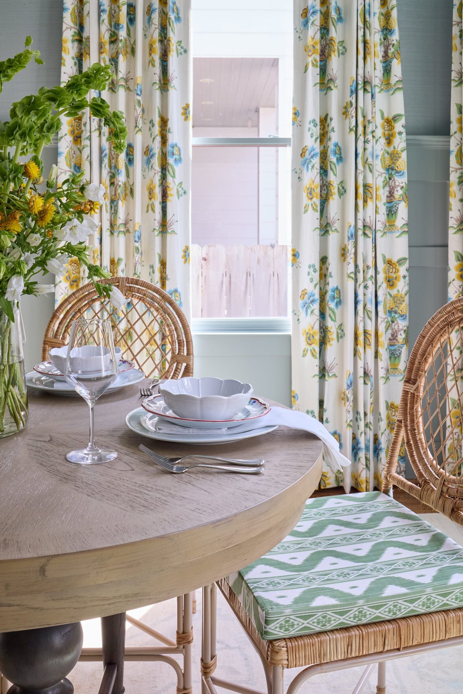 vision and hammer dining room with wooden table and colorful curtains and green and blue accentsjpg