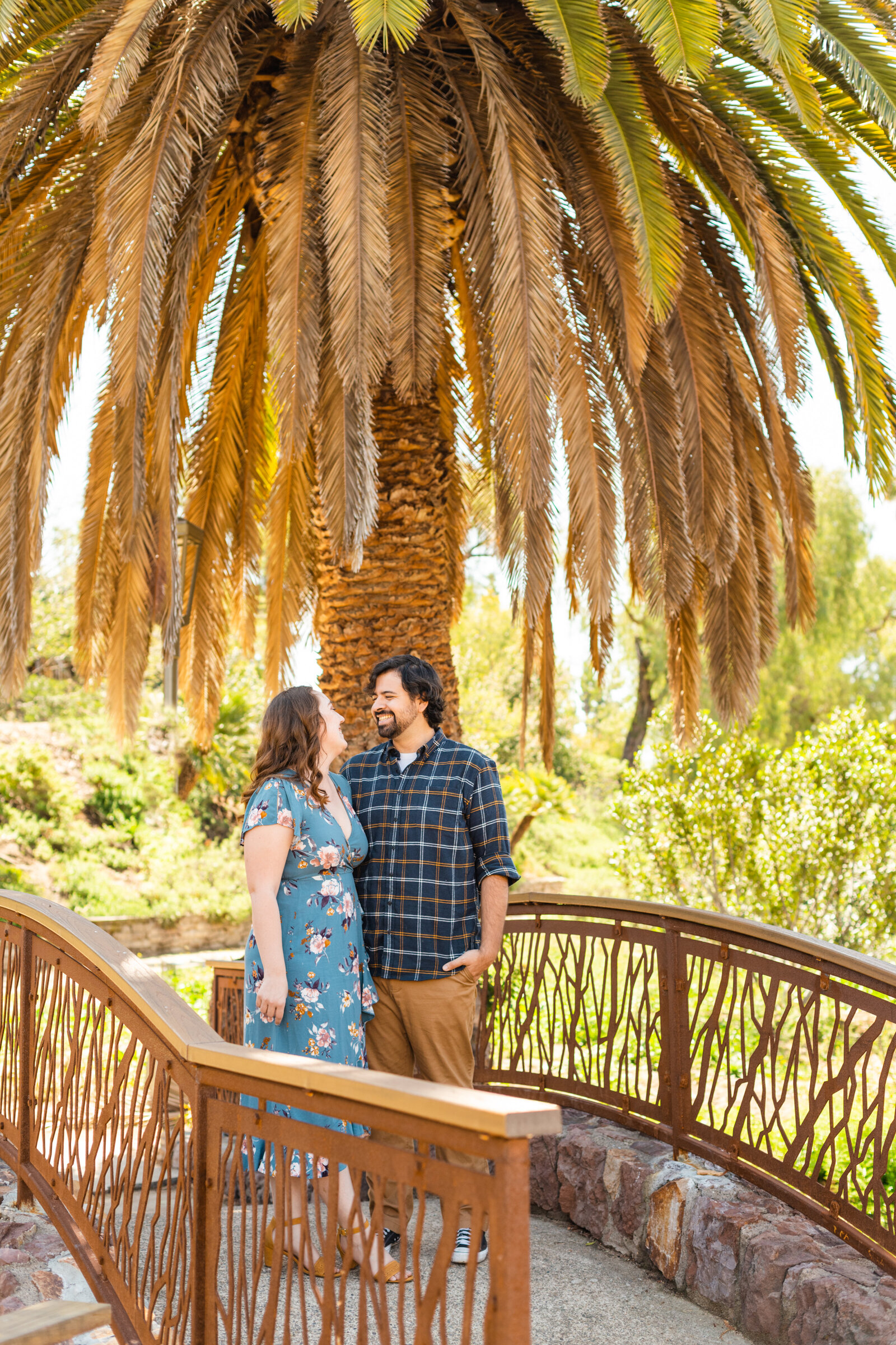 An engaged couple poses for photos in a garden in Los Angeles, Ca.