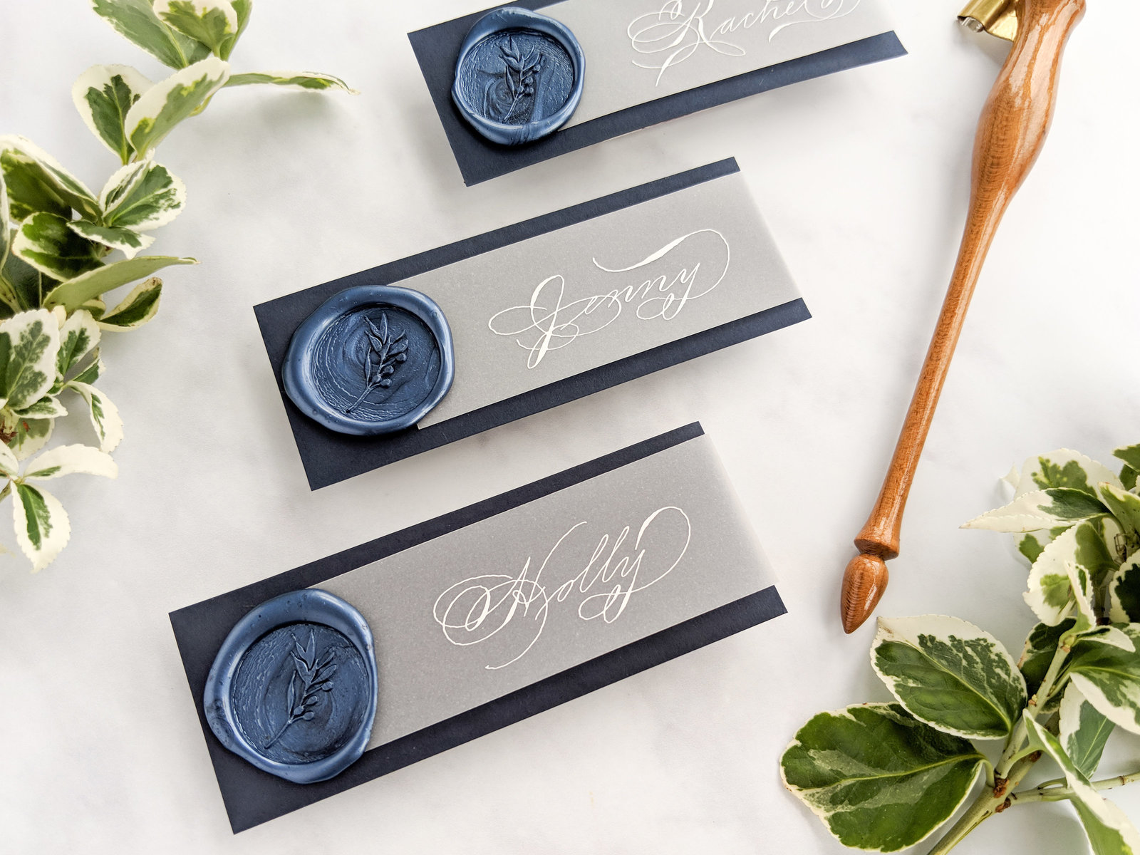 Navy and white place cards with wax seal, vellum and calligrpahy