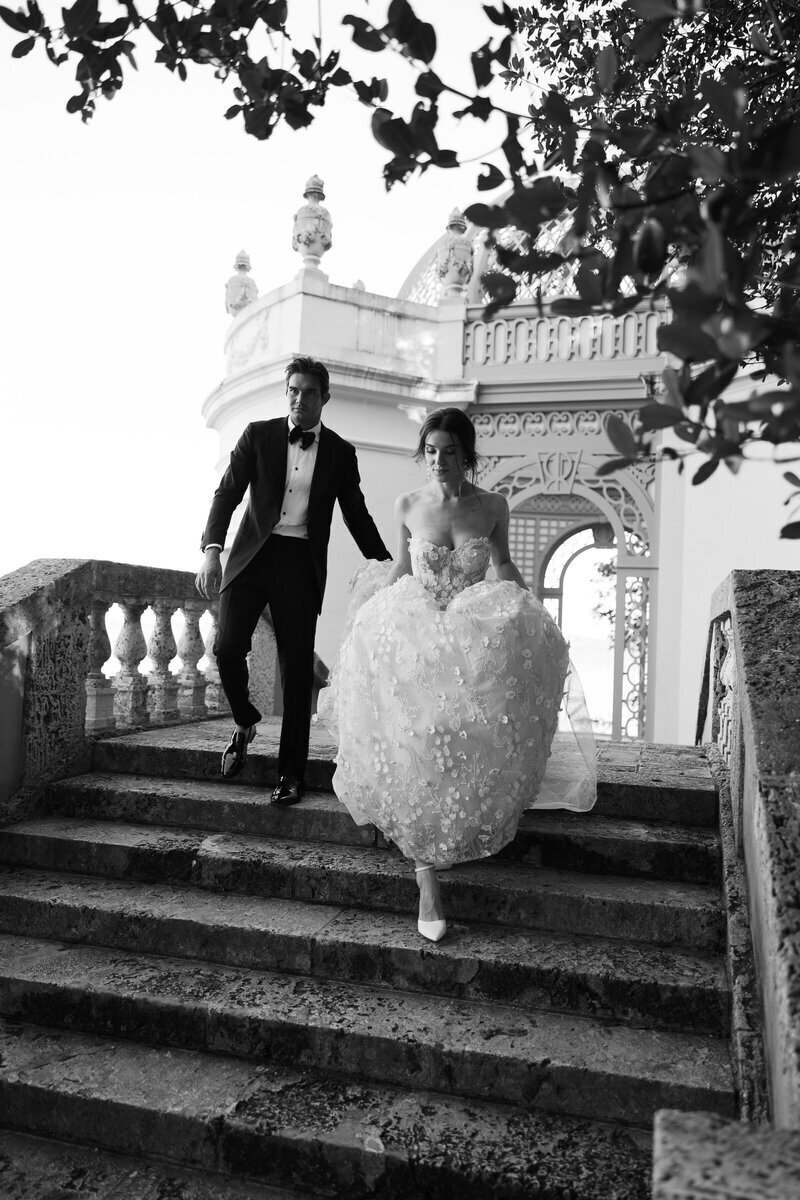 bride and groom walking down stairs, taken by fort myers florida wedding photographers