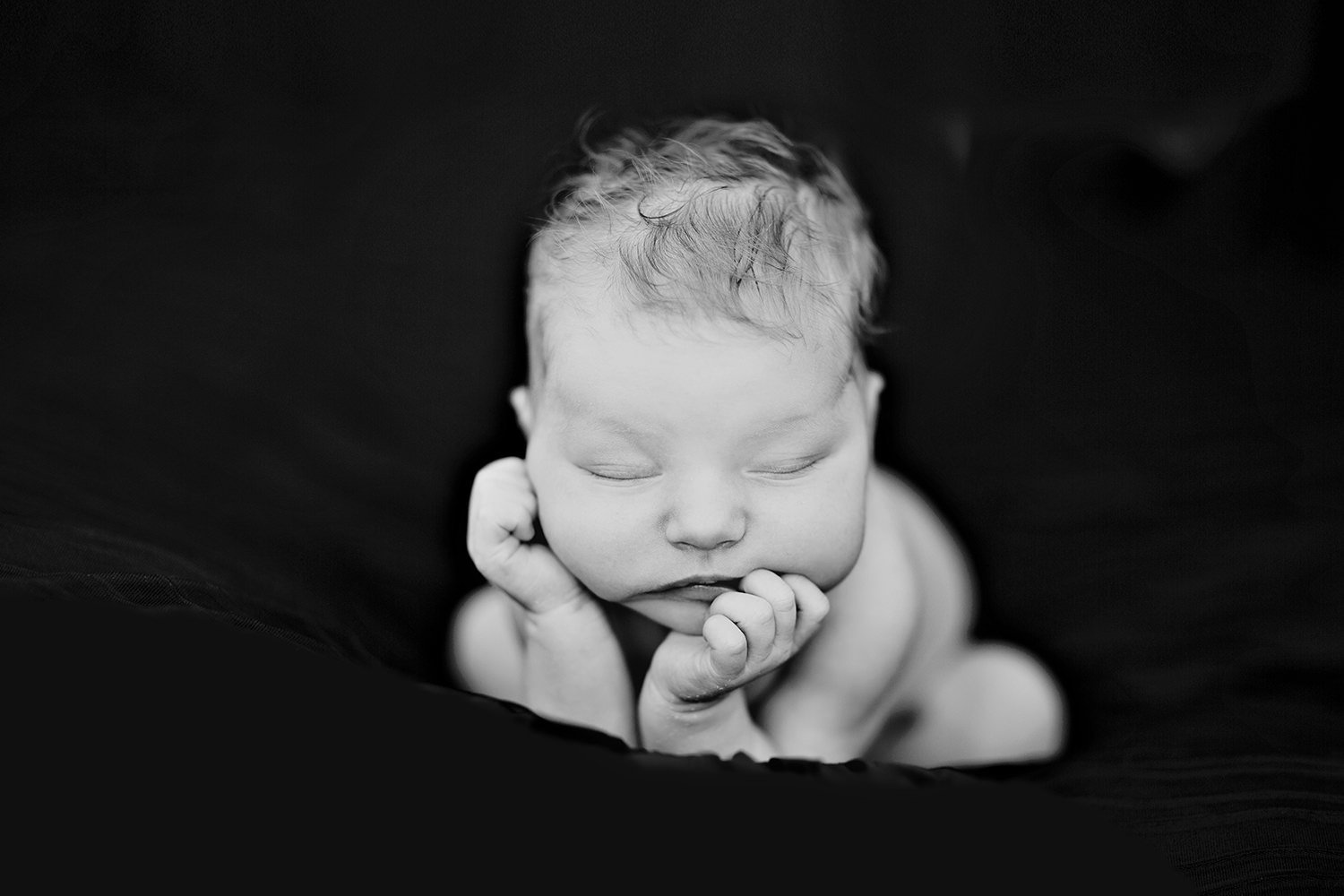 san diego wedding photographer | black and white photo with newborn sleeping with arms holding head up