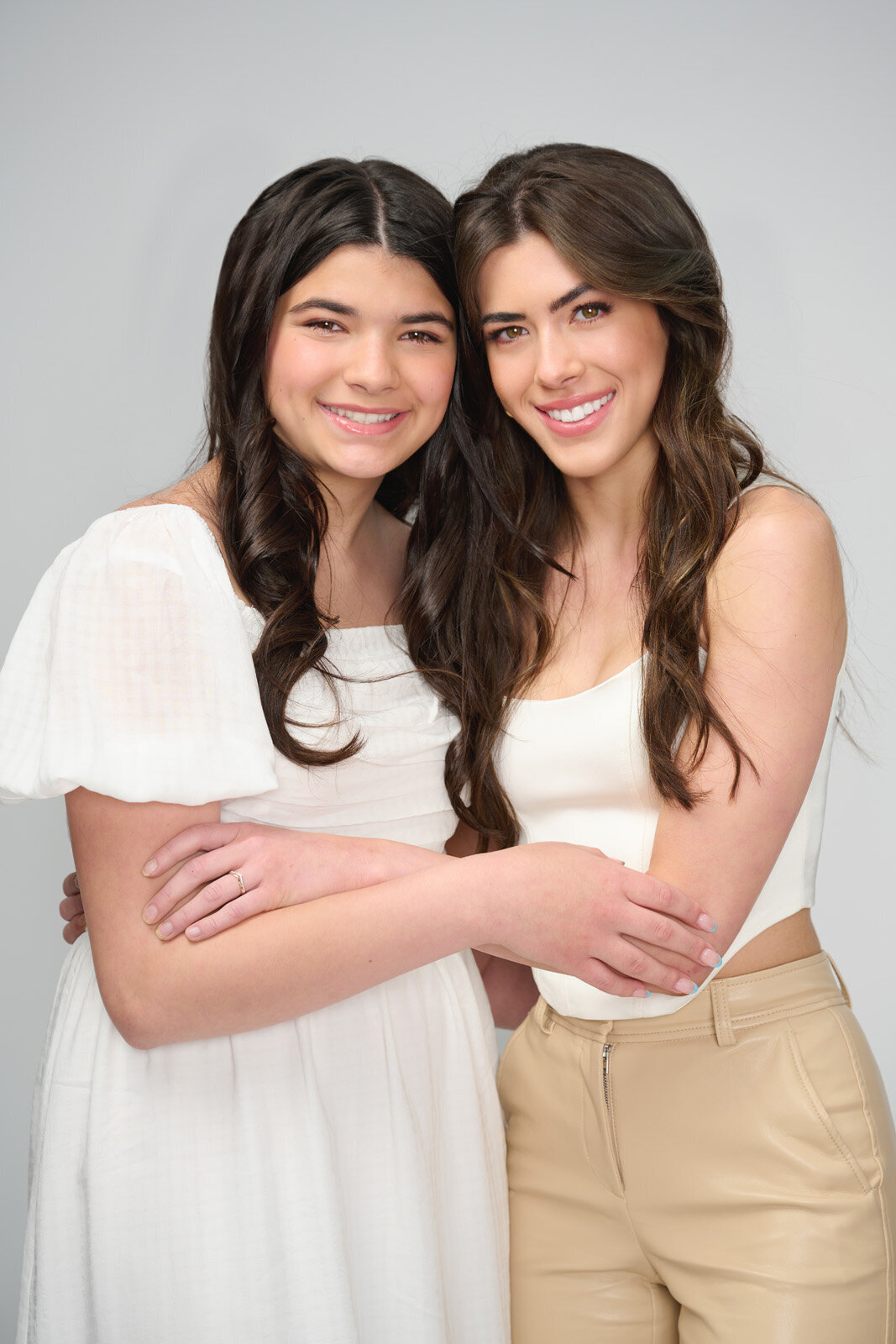 Warm Embrace of Two Smiling Women in Casual Outfits-10