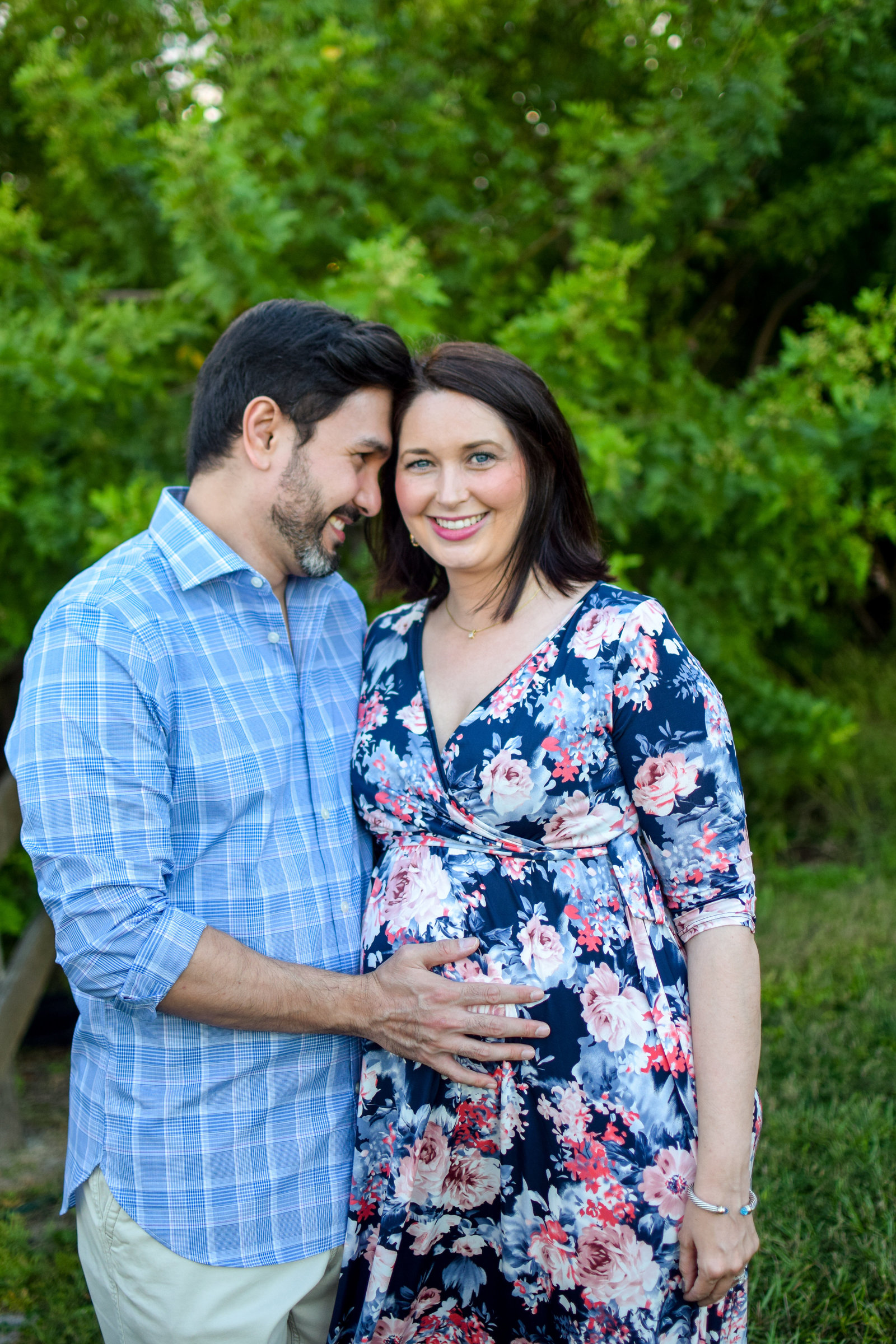 Maternity pregnant couple smiling holding baby bump Tucker Ranch Winter Garden Florida