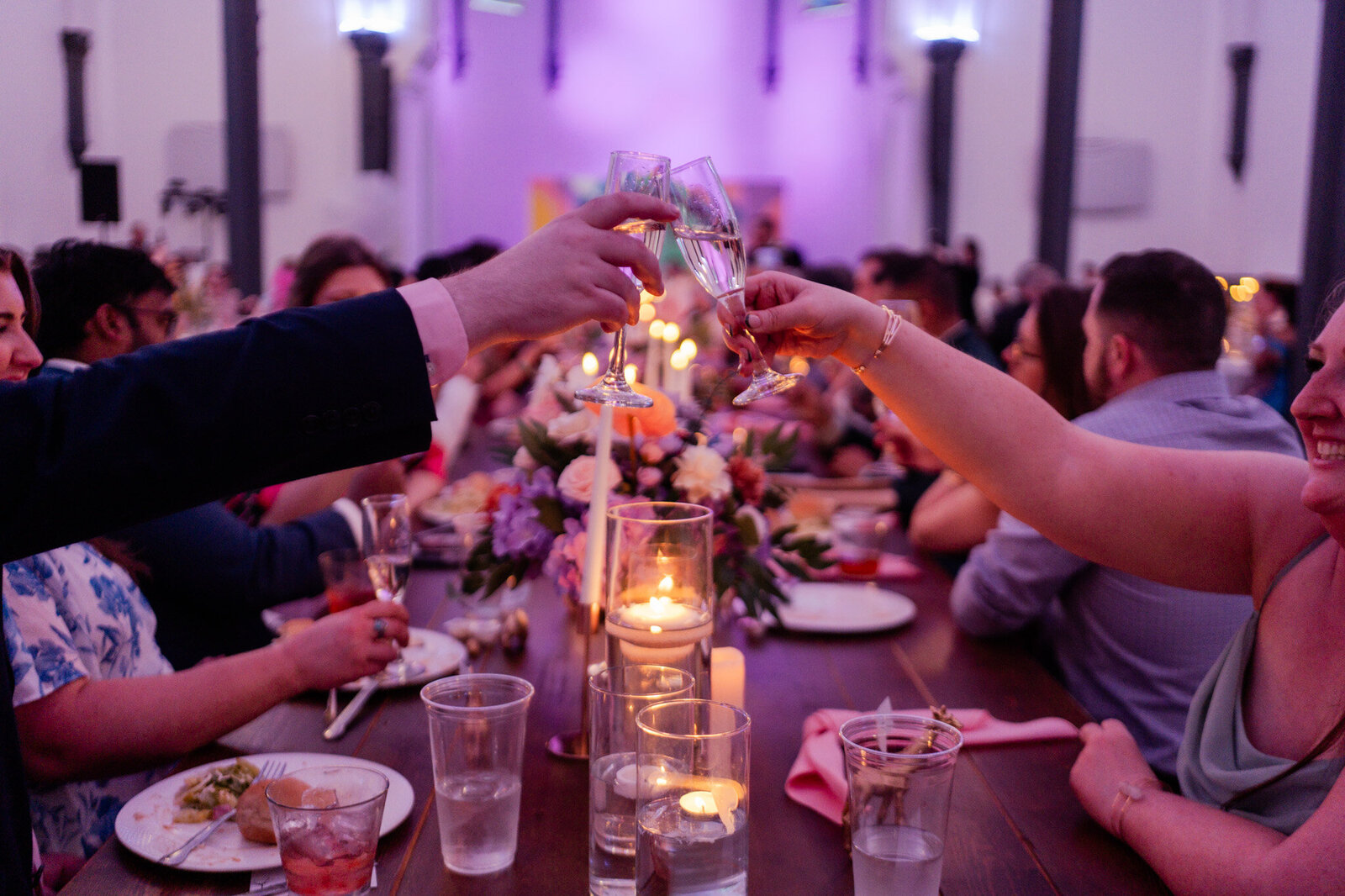 wedding guests cheering their drinks