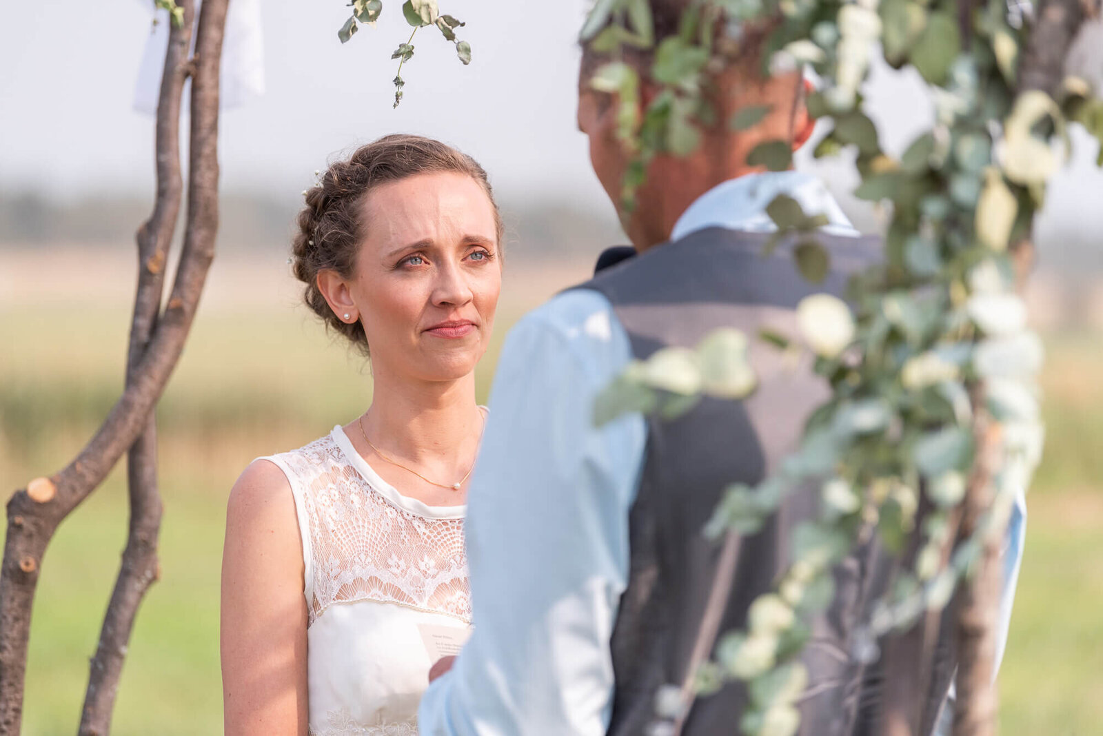 Bride facingher groom at the altar