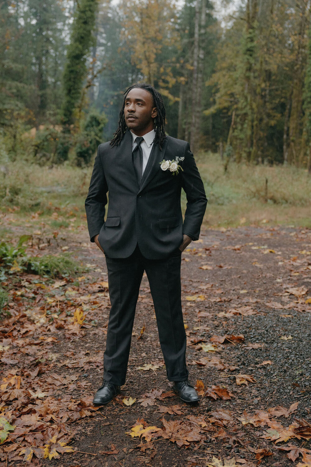 Groom on suit standing outdoors