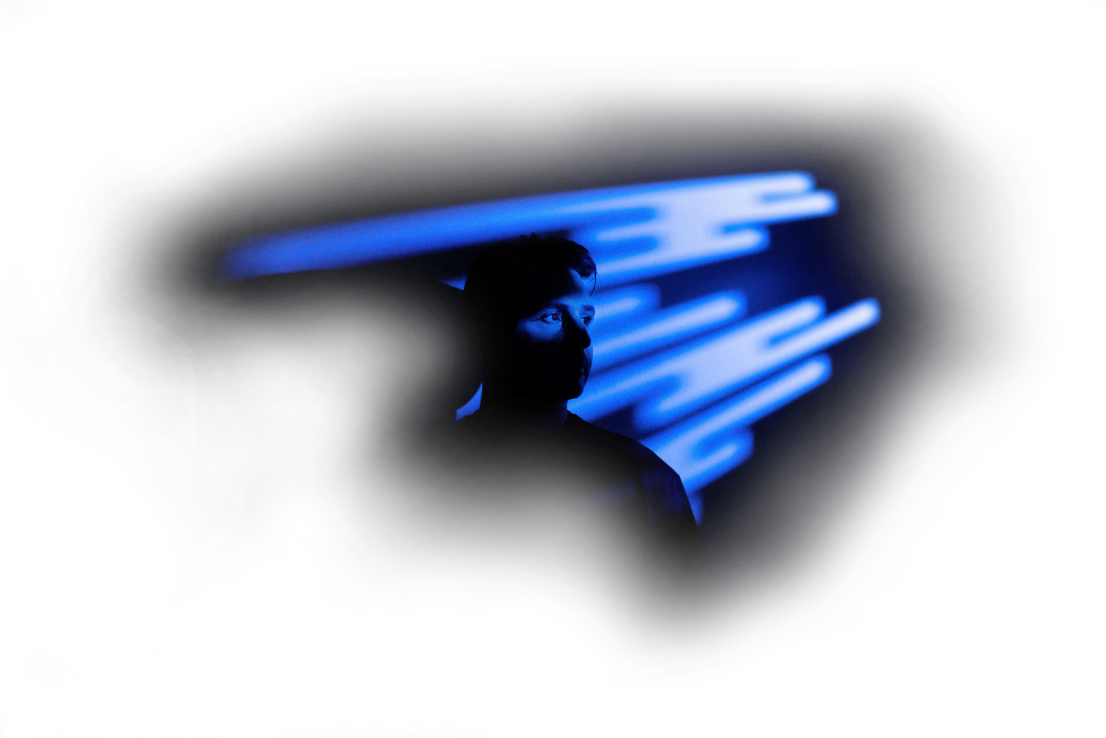 Portrait of Nahuel Aseff in dramatic lighting with blue tones and artistic blur effects.