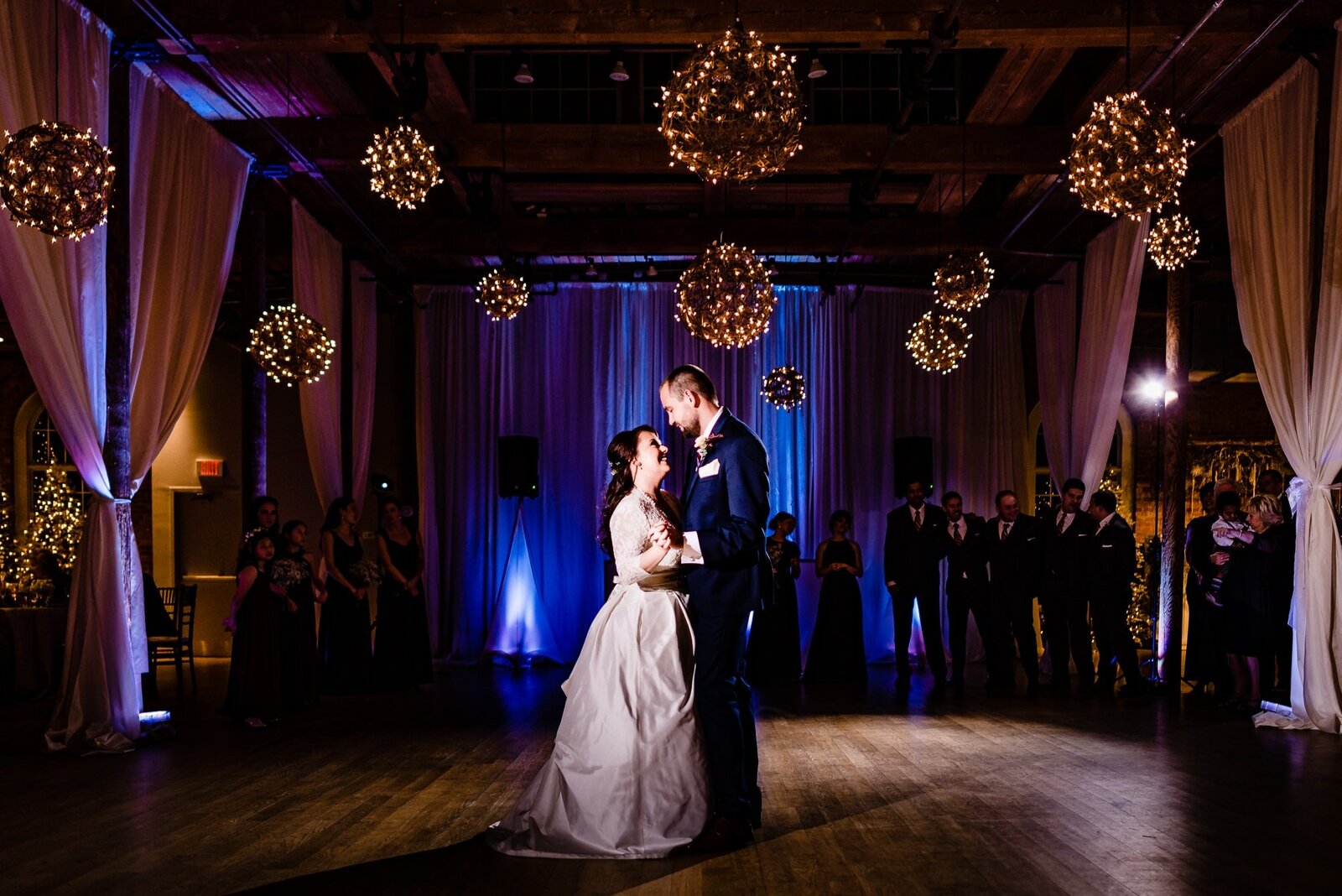 Couple in wedding attire shares their first dance at The Cotton Room