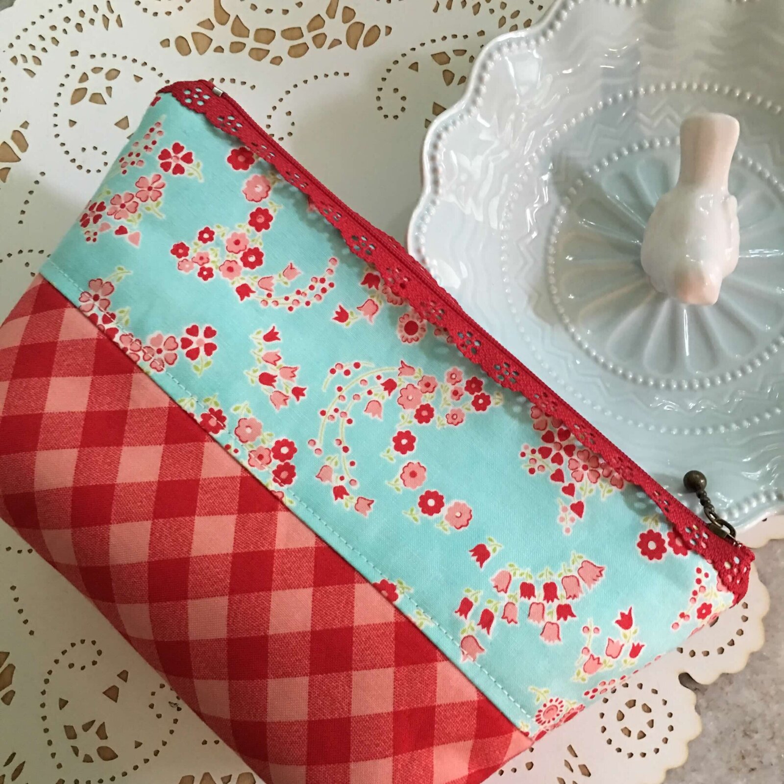 Small hand made pouch laying on its side