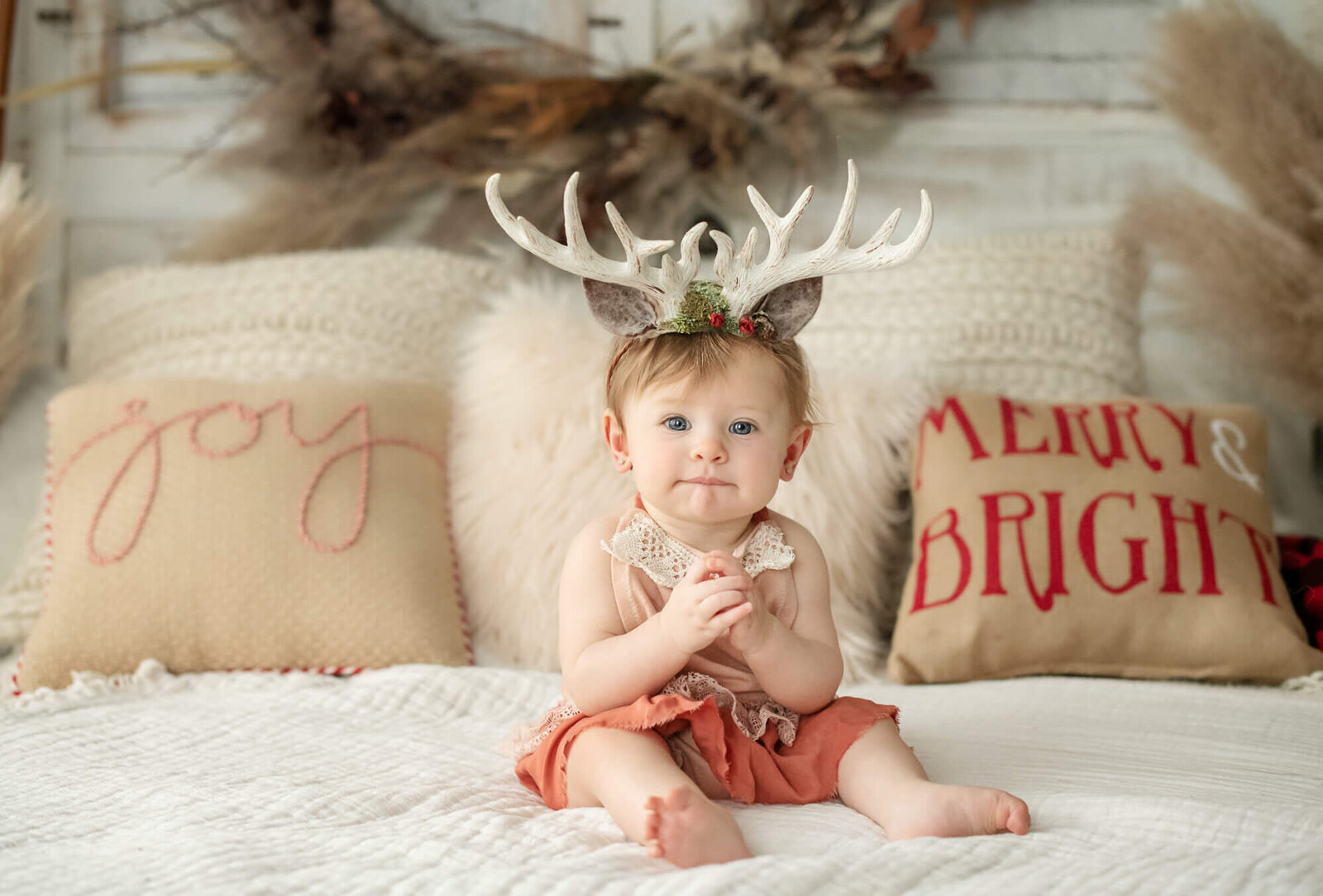 7 month old girl with deer antler headpiece in Christmas set