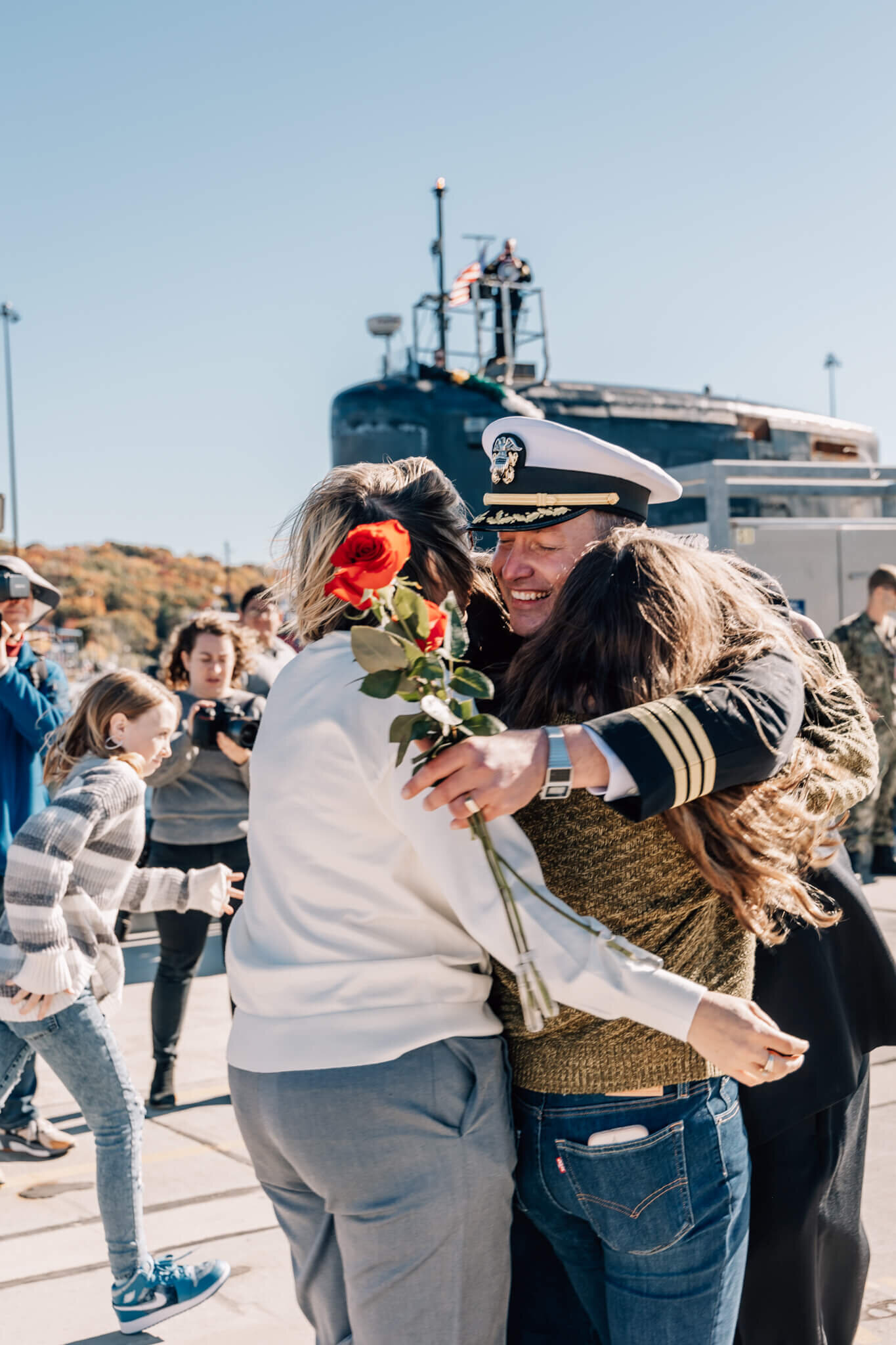 Submarine officer hugs family at emotional USS North Dakota homecoming at SUBASE New London in Groton, CT.