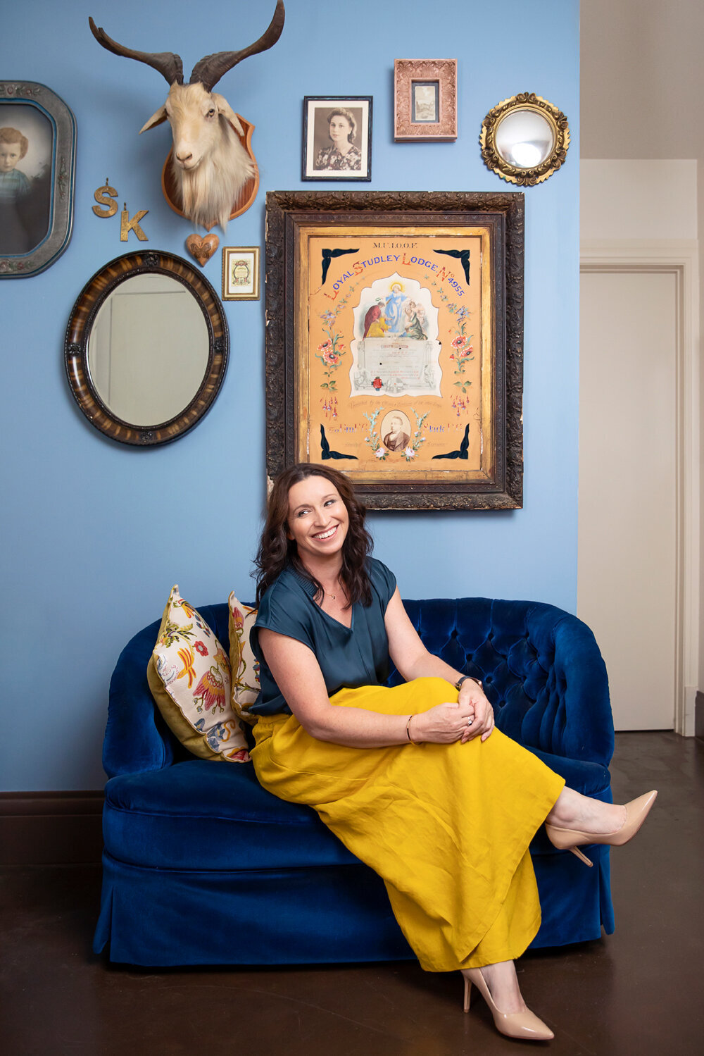 Business woman sitting on a blue couch