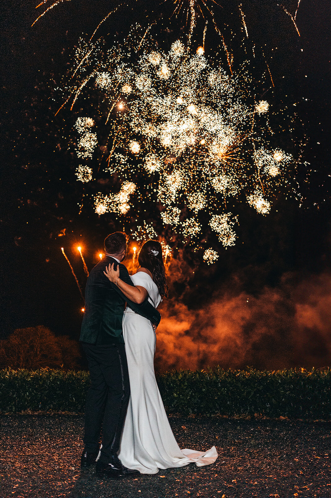 bride and groom watch fireworks