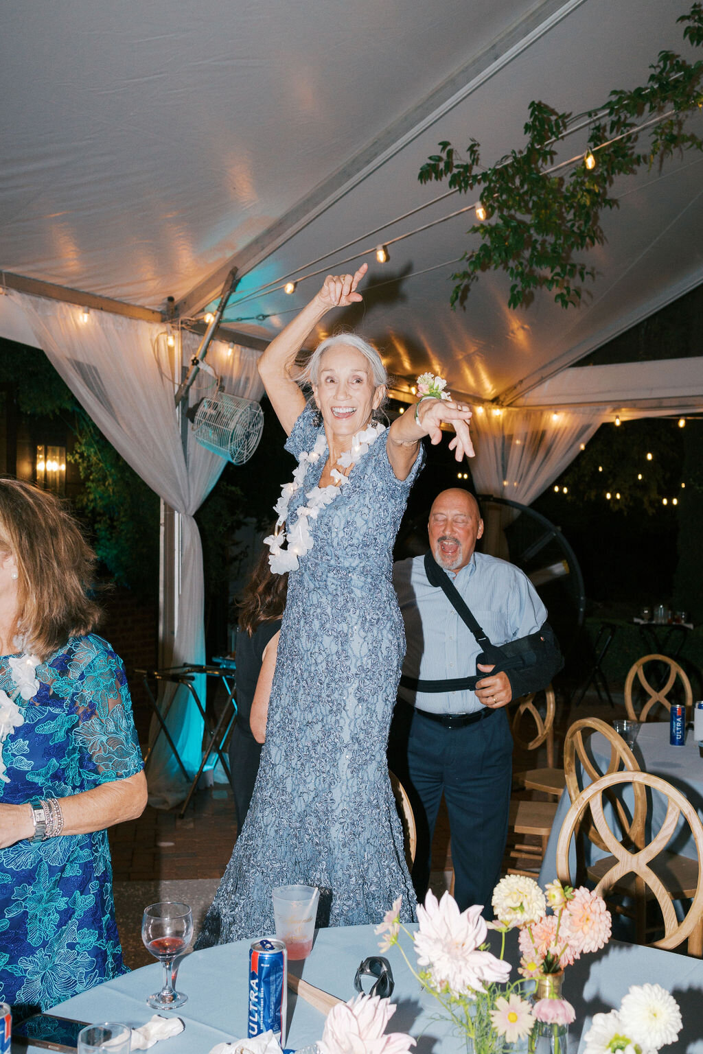 Mother of groom dances on table at reception