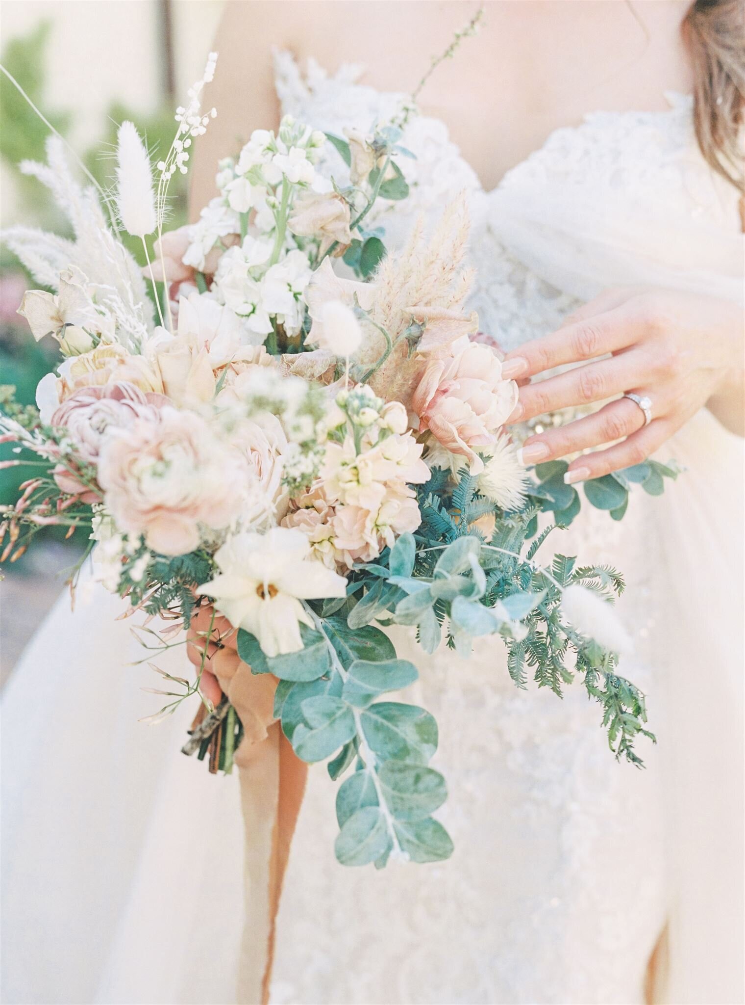bridal bouquet with greenery and light pink and white flowers
