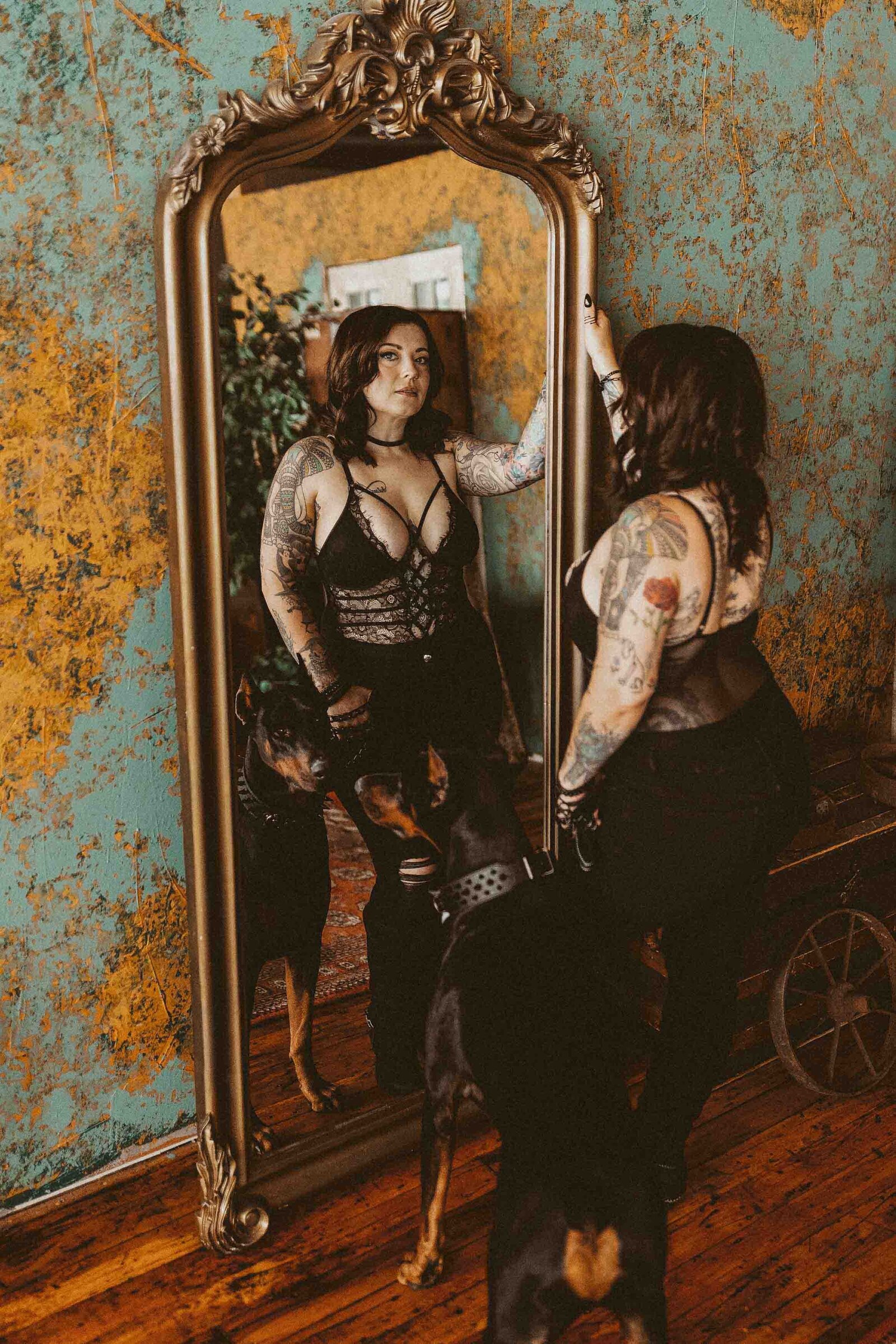 woman holding her dog in front of a mirror