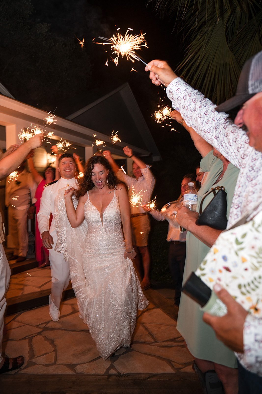 A couple joyfully exiting their wedding ceremony, captured in a candid moment by CMH Studios during their San Antonio wedding.