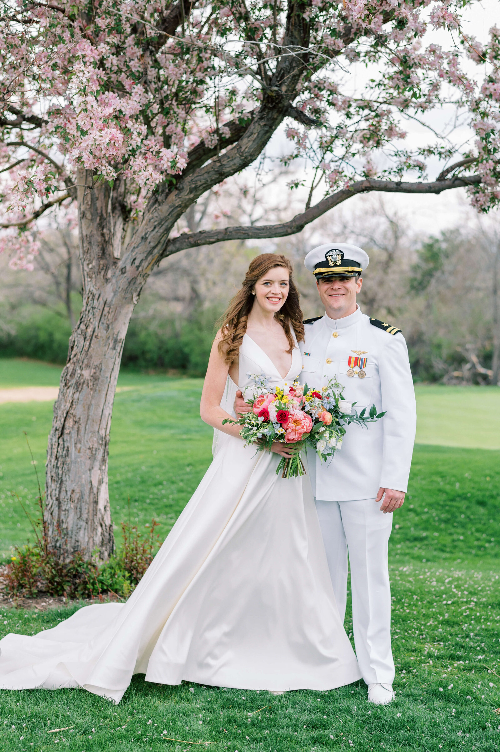 Naval officer and his bride take a picture together at their Virginia wedding
