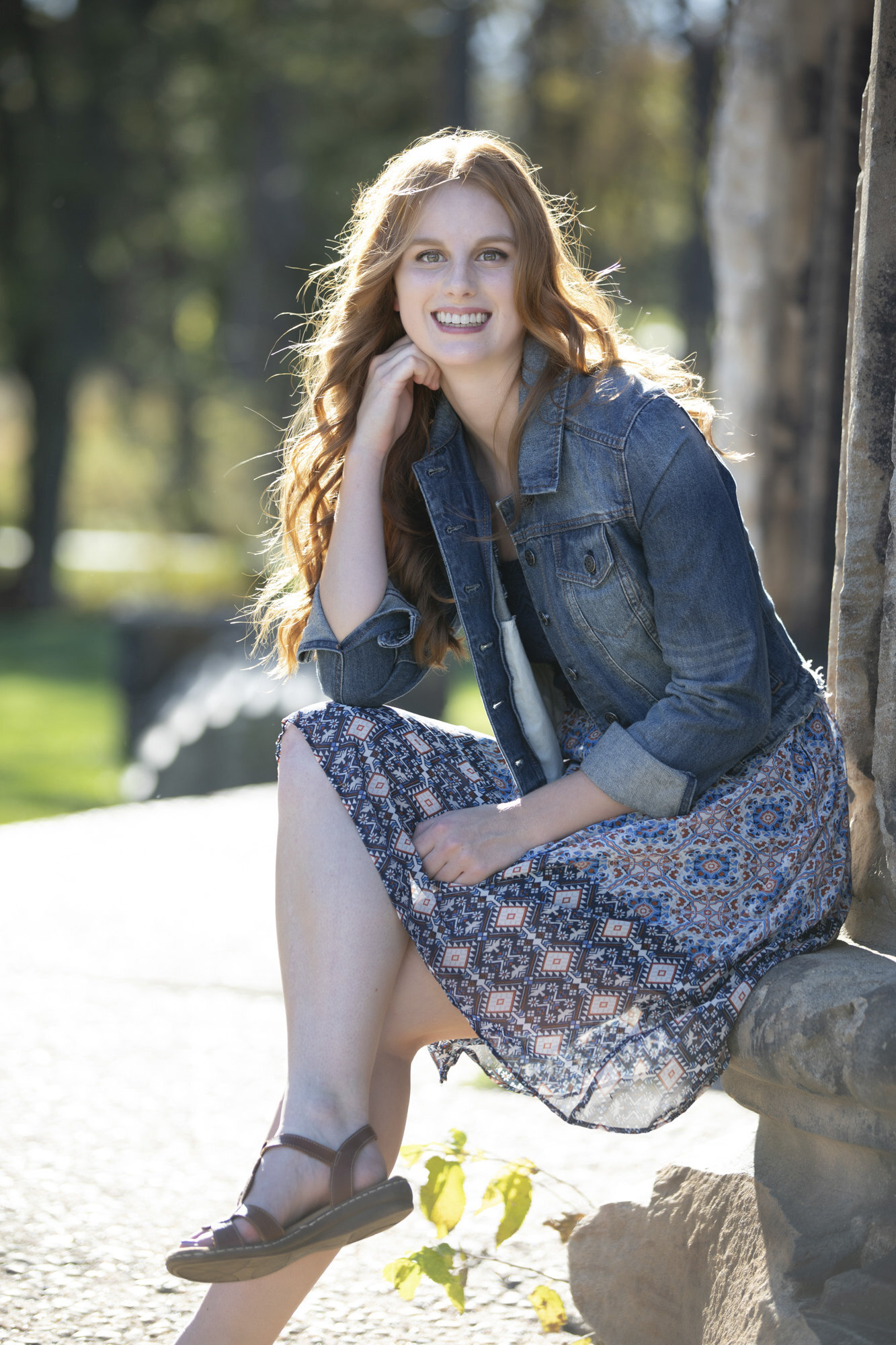 Senior sits on a column in Pioneers Park