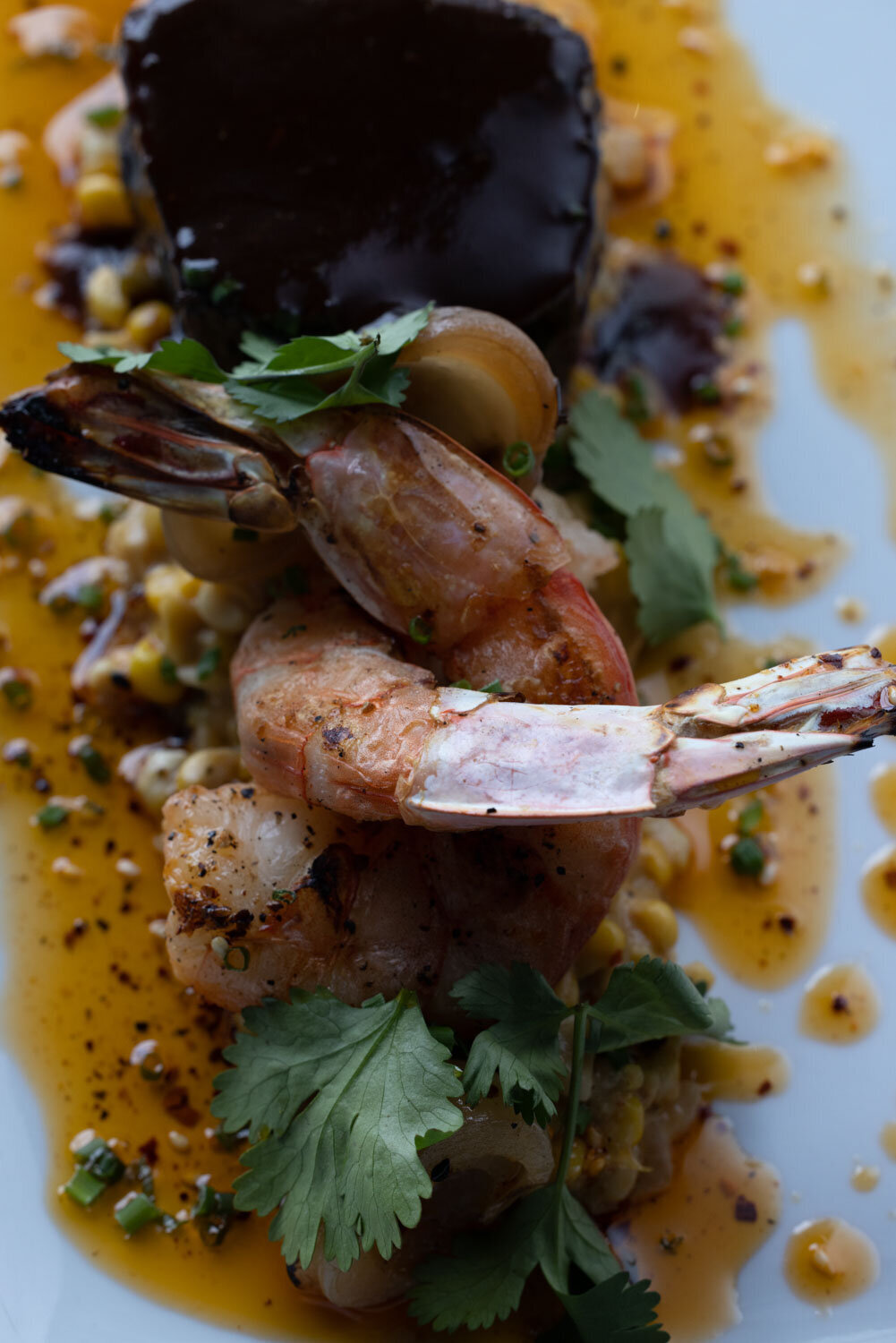 A close up of a plate of food with shrimp and vegetables