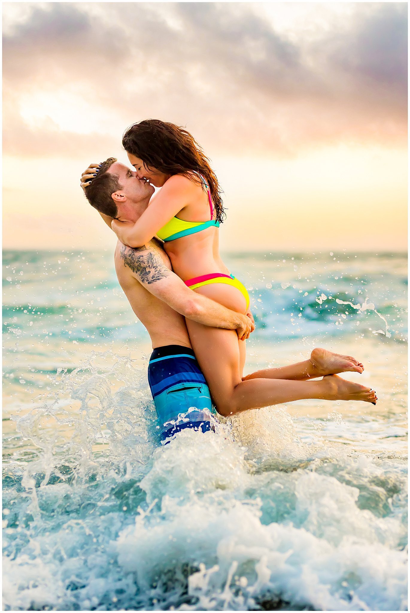 San Diego couple kissing in the ocean waves