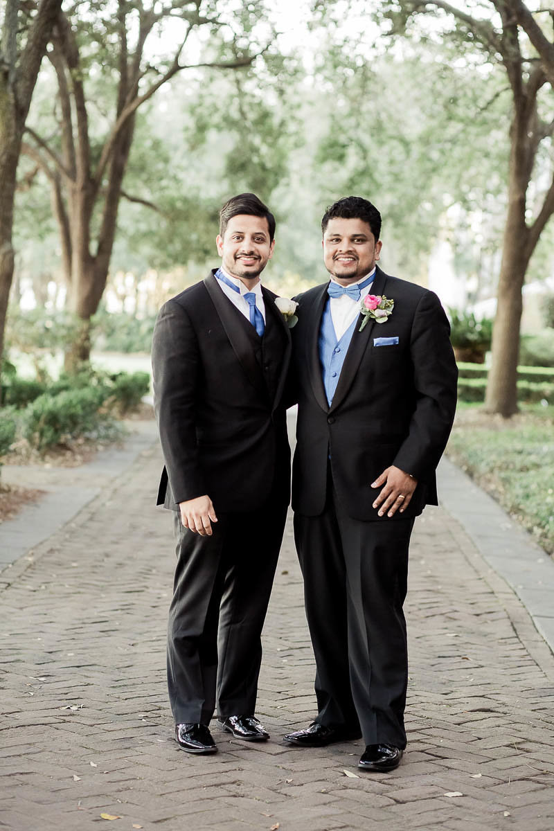 Groom and groomsmen stand under trees at Waterfront Park, South Carolina
