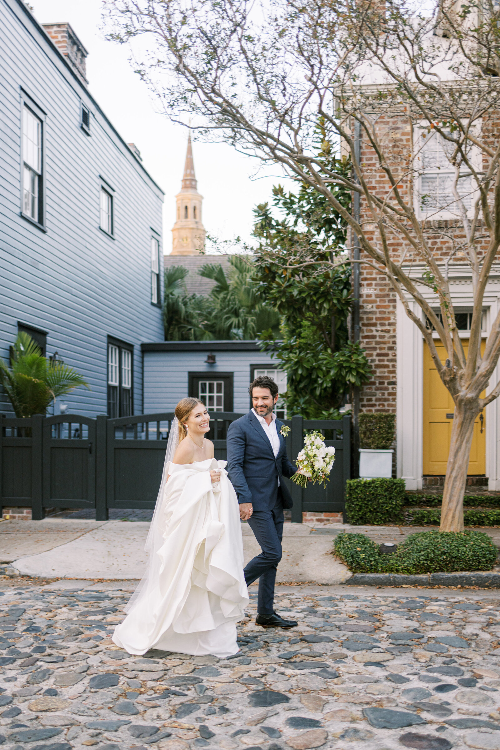 Couple strolling in downtown Charleston after their wedding