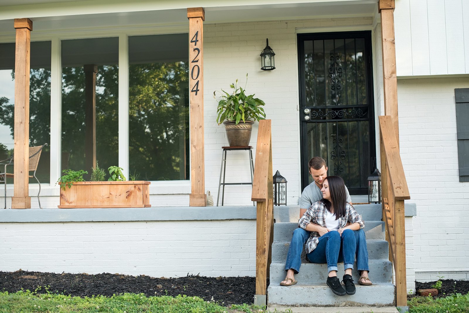 Lifestyle photo of couple sitting outside on the front porch
