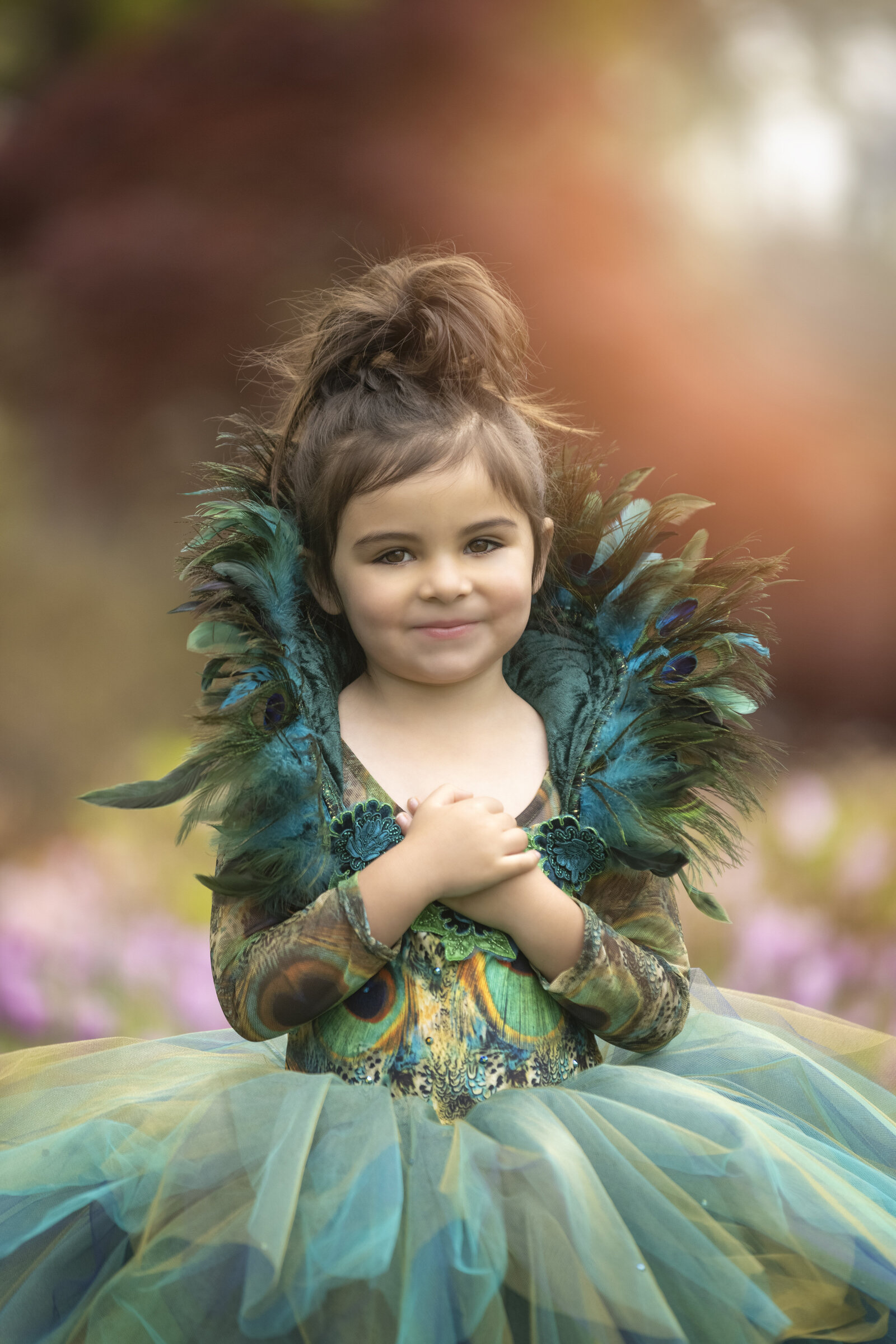Young girl in peacock dress at Dallas Arboretum
