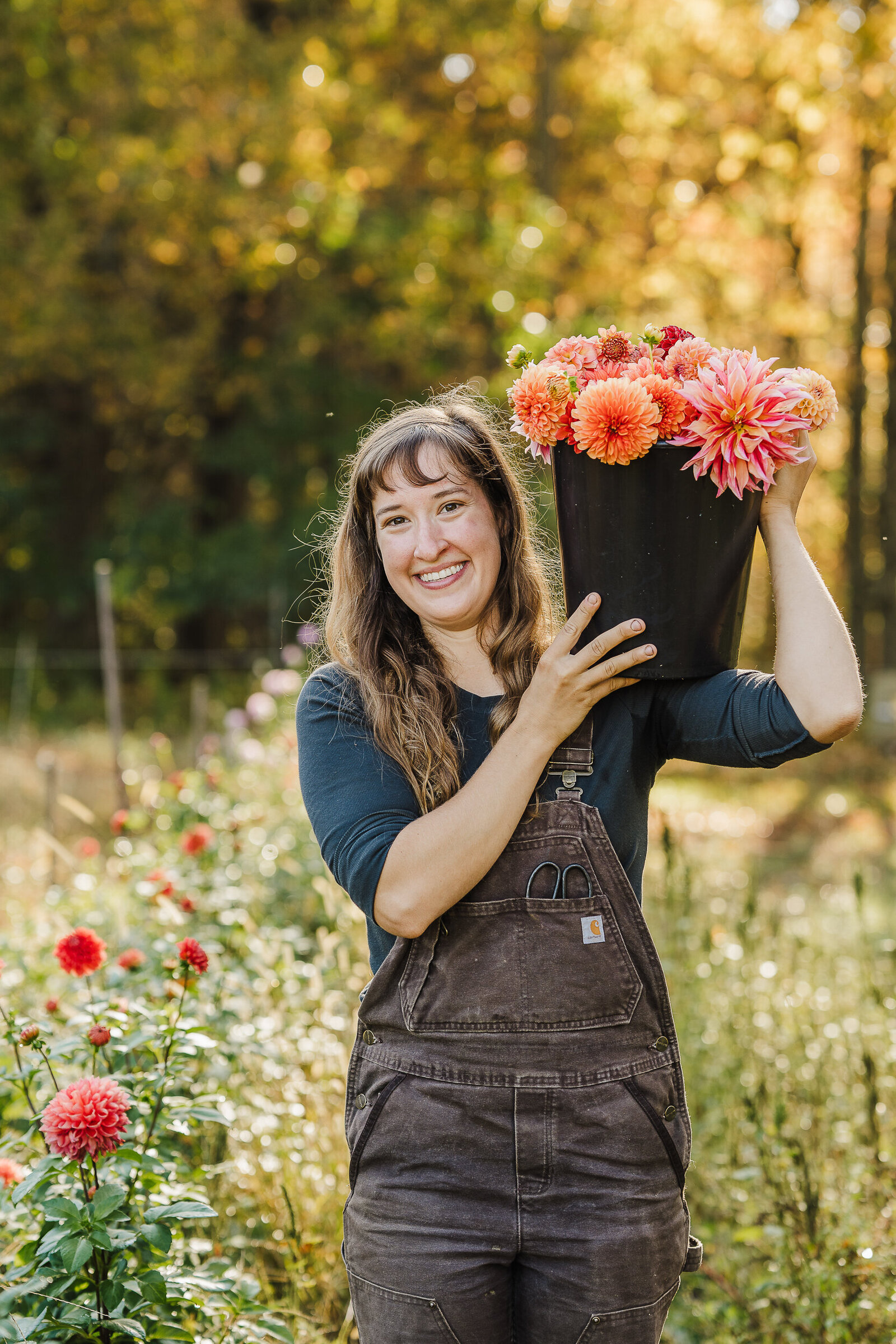 flower farmer poses with bucket of flowers during photoshoot