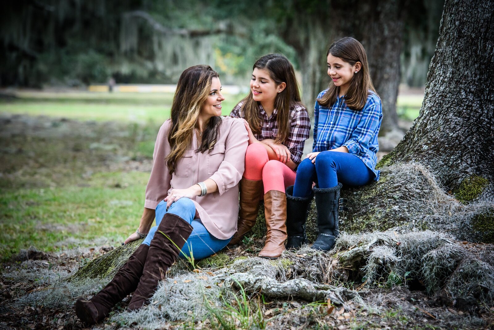 Family portrait of mom and girls sitting by tree at Fontainebleau State Park in Mandeville
