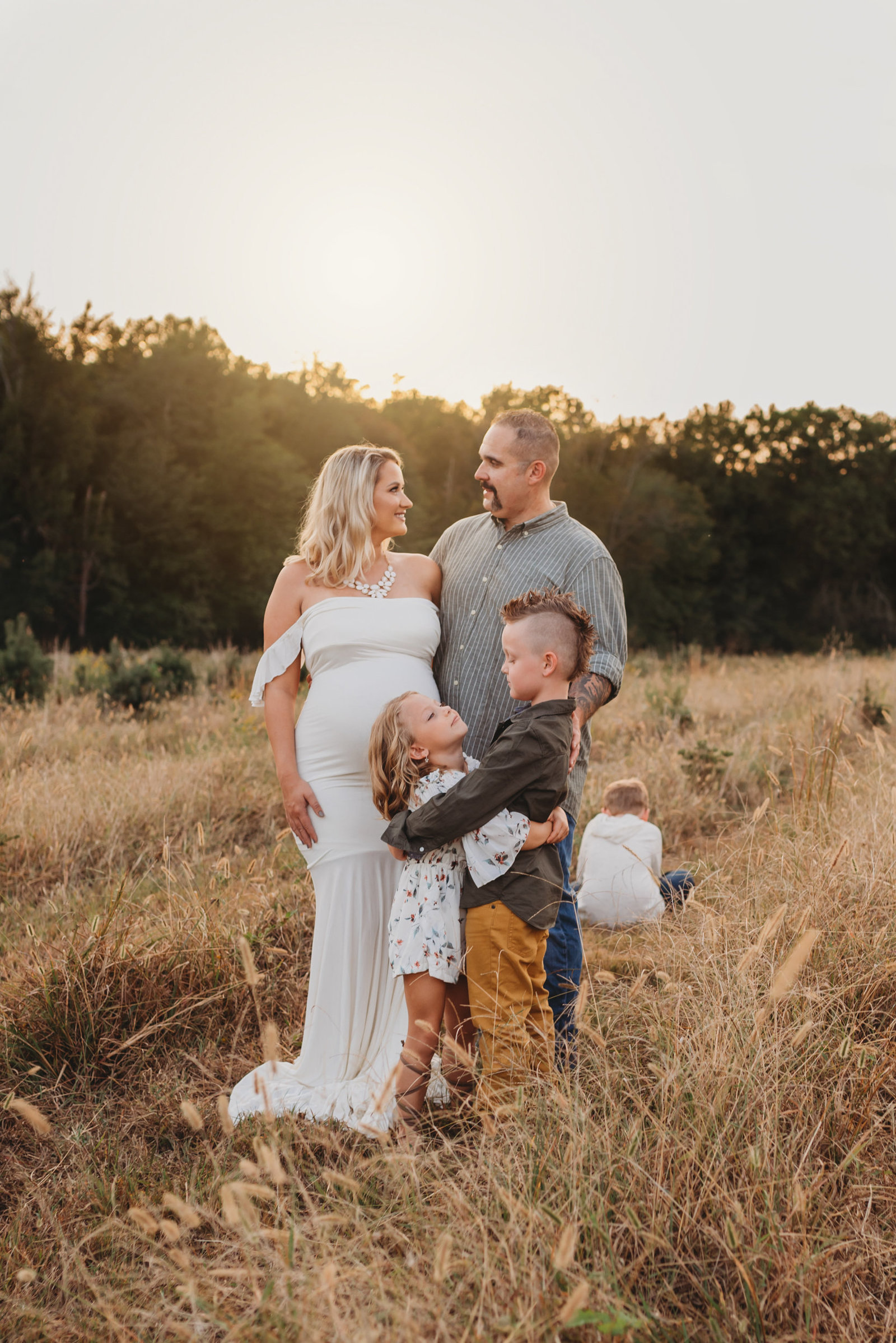 outdoor family maternity session in field in Tampa