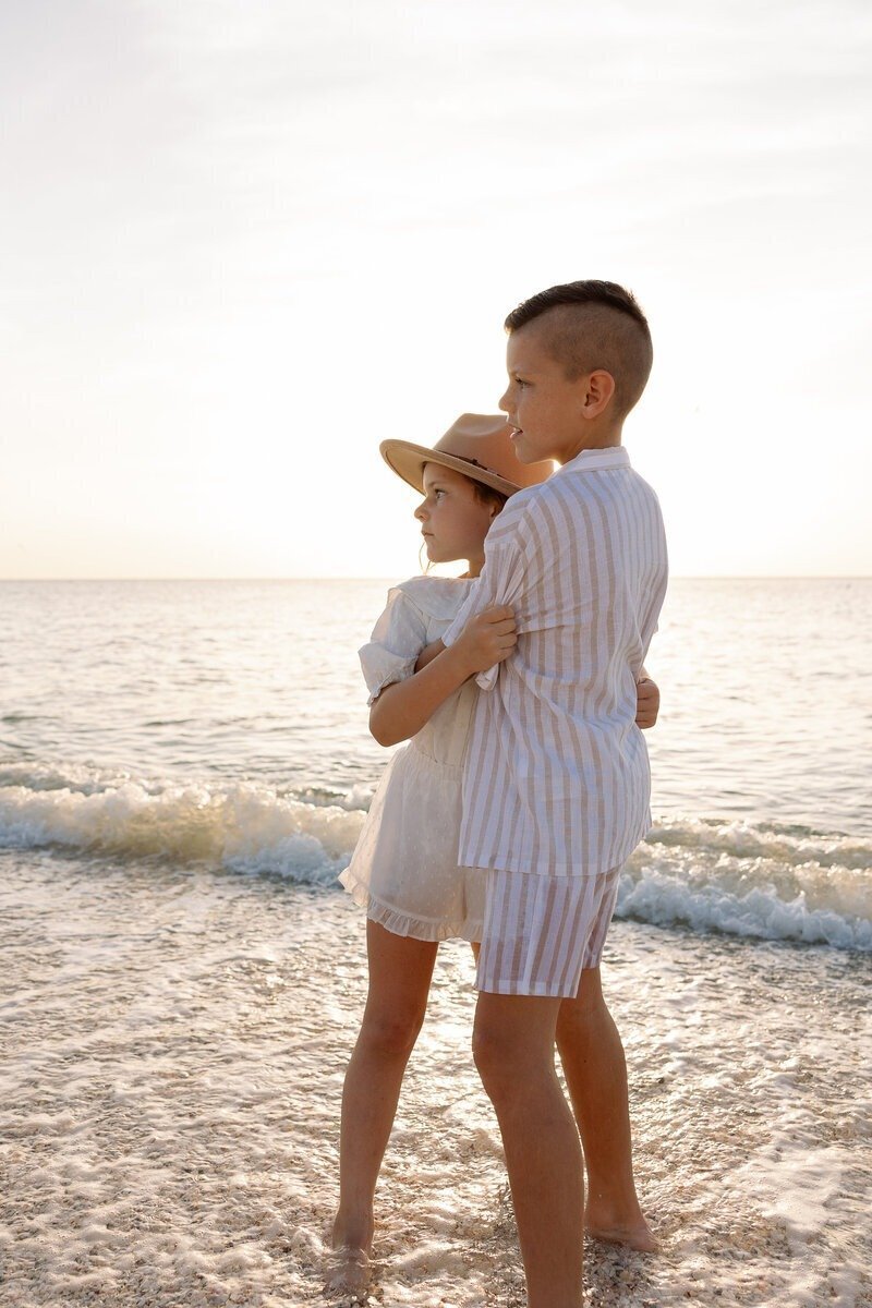siblings hugging, taken by naples fl family photographer