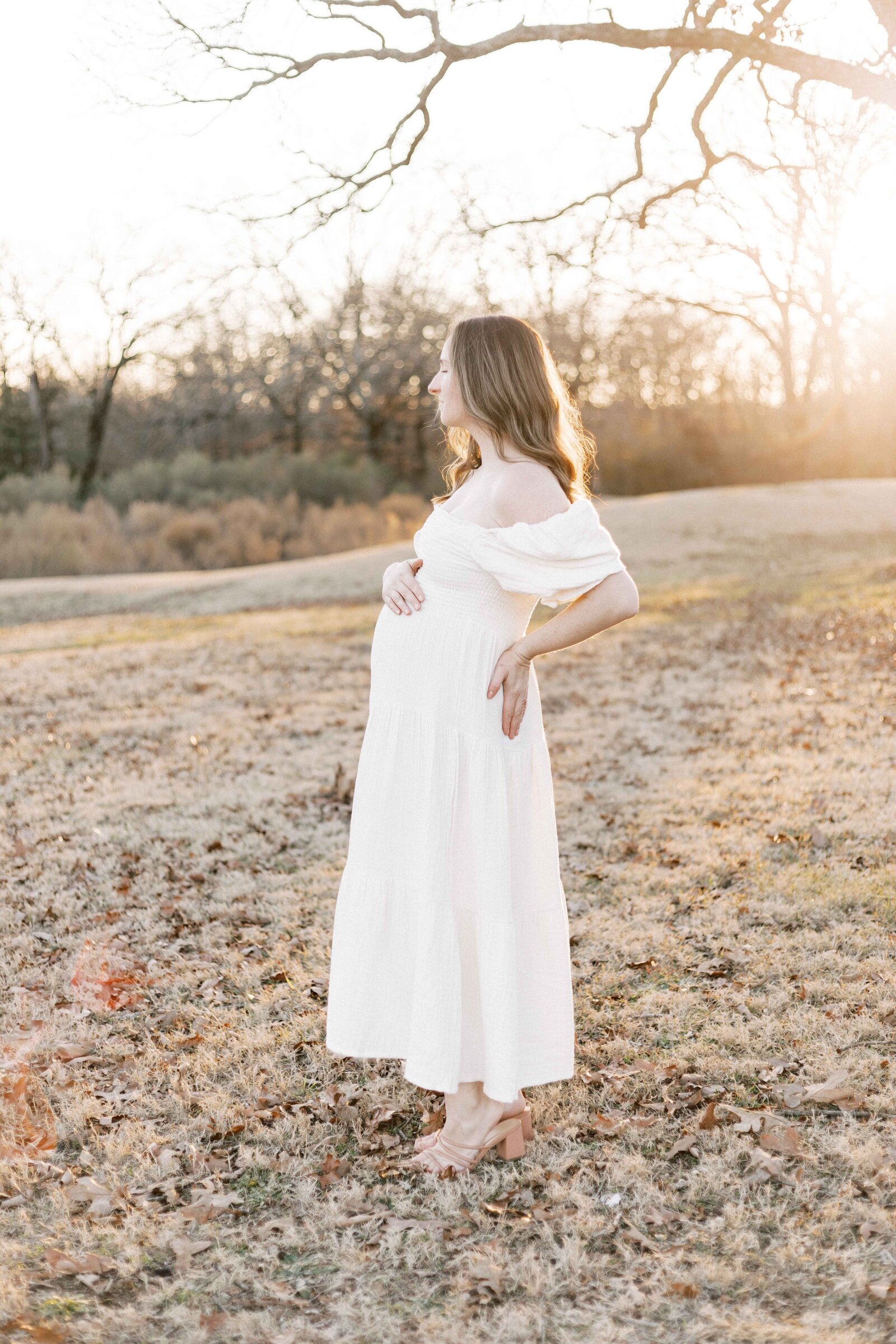 pregnant woman standing at sunset in maternity photos in peoria illinois 