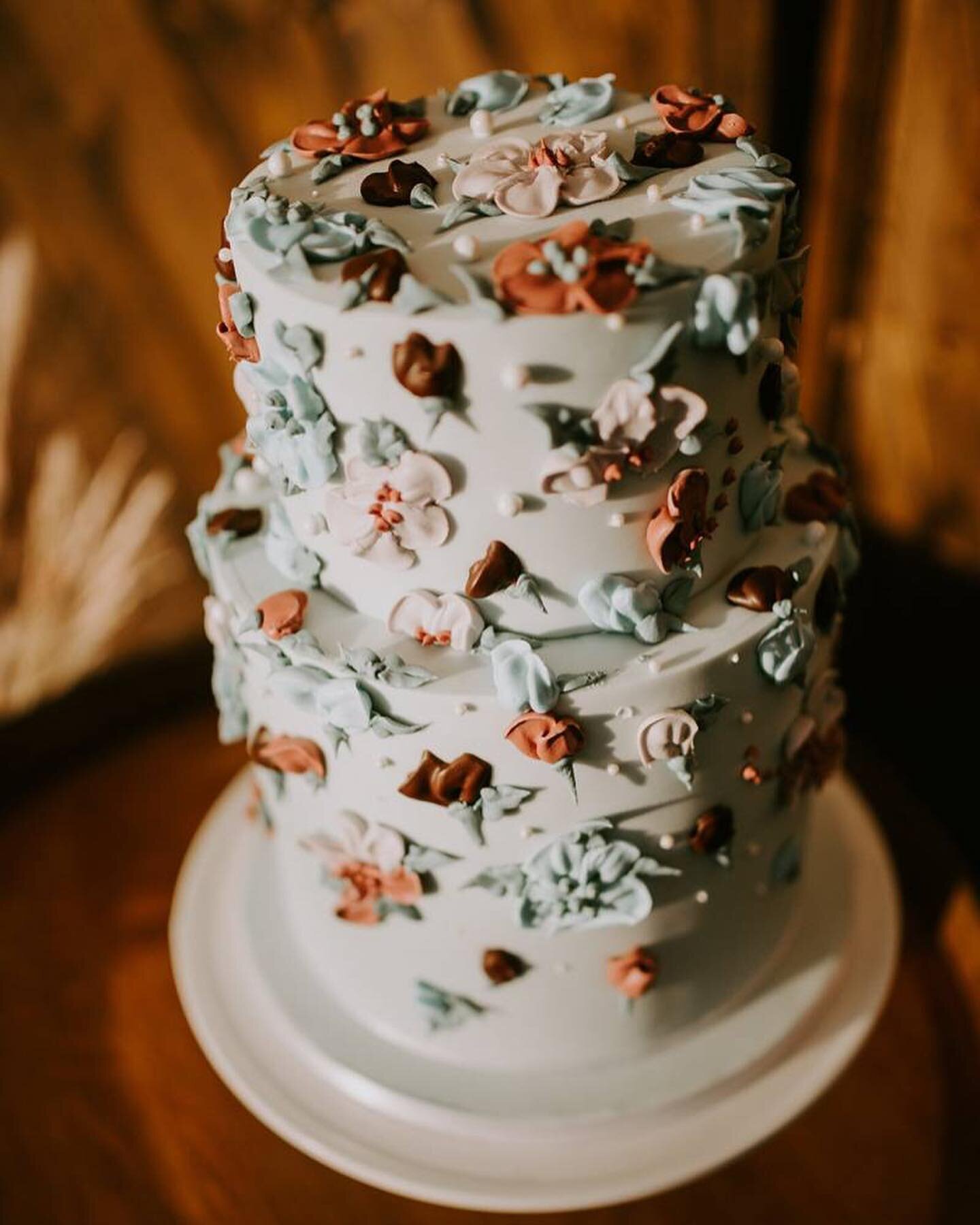 light blue wedding cake with small icing flowers