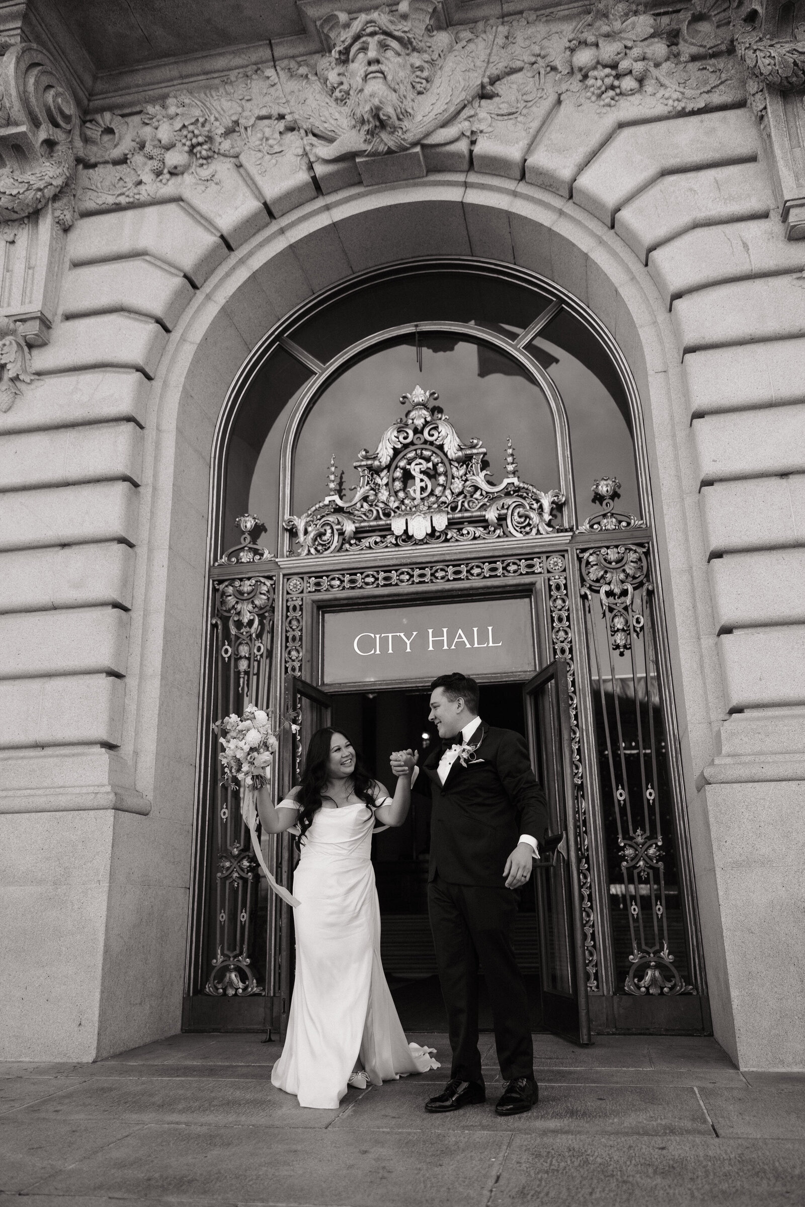 Bride and groom celebrate outside San Francisco City Hall after intimate ceremony