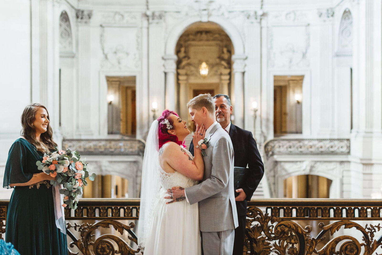 bride with pink hair kissing groom on Mayor's Balcony