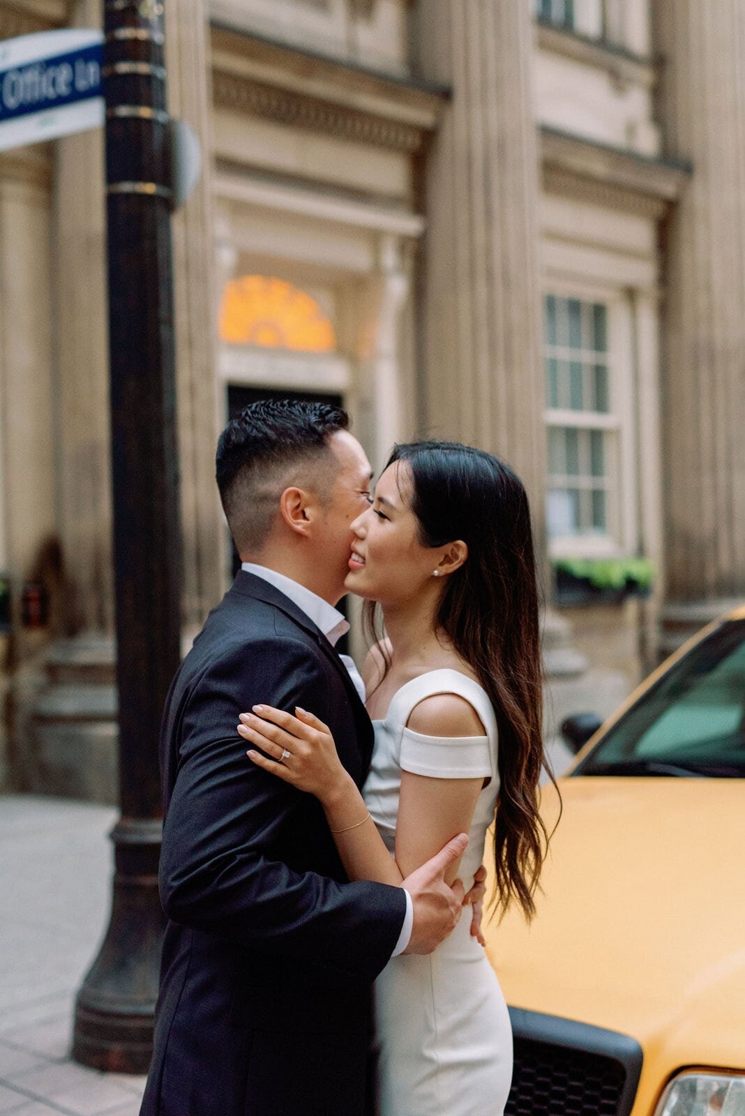 Editorial Couple embraces on city street downtown toronto modern romantic engagement session Jacqueline James Photography
