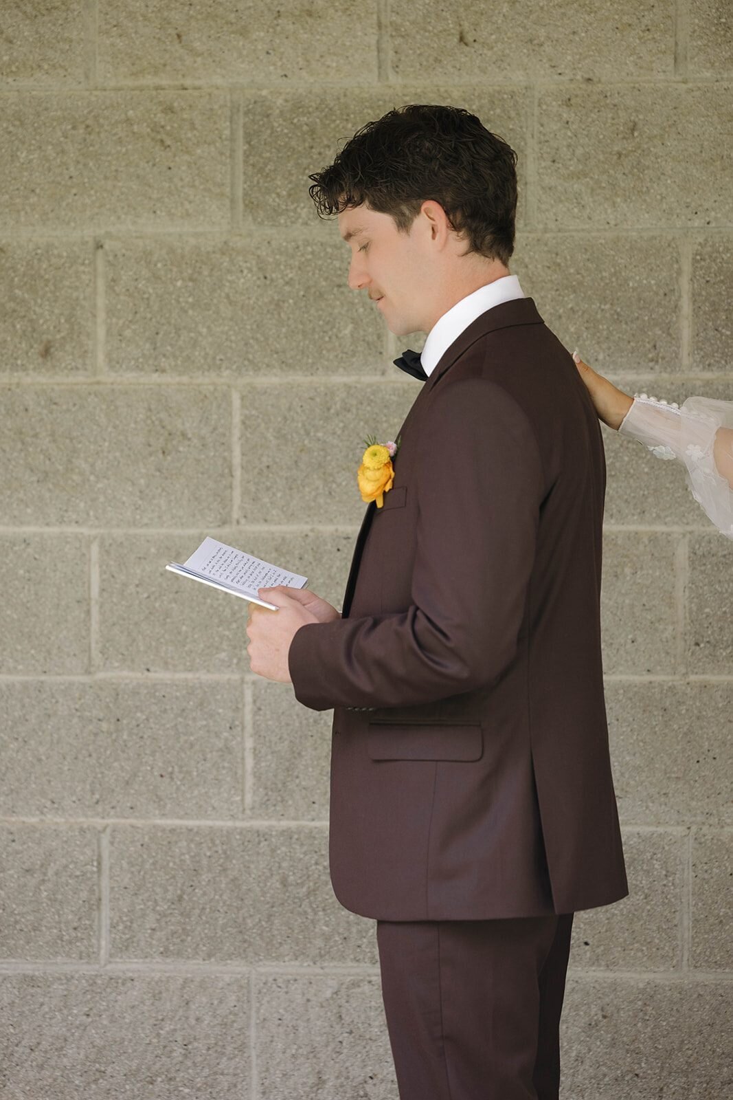 Groom reading a letter from the bride before the ceremony