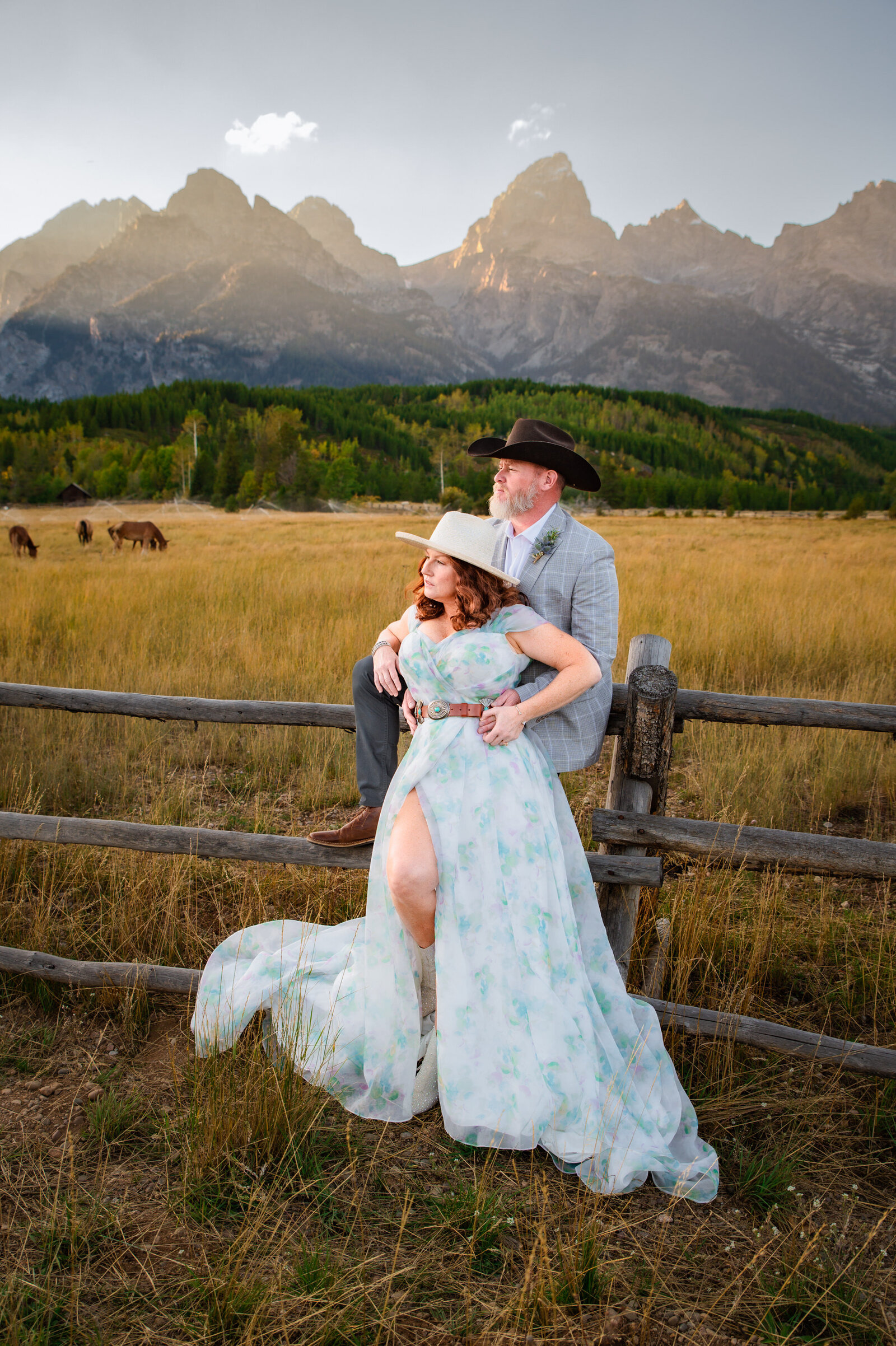 Jackson Hole photographers capture couple leaning against fence after Grand Teton wedding