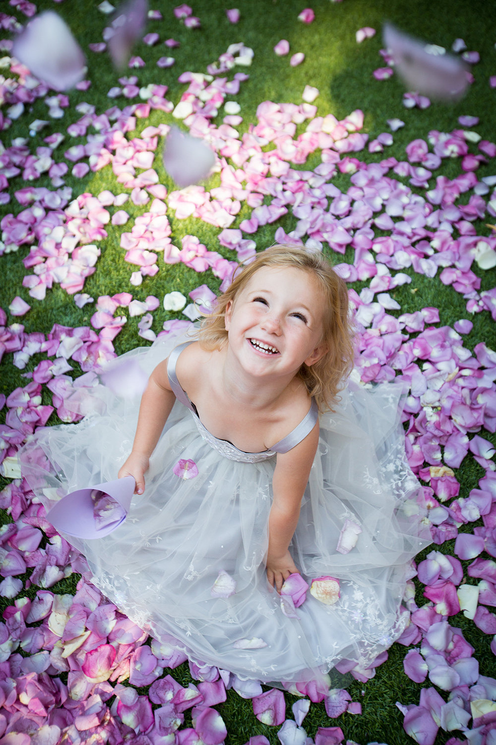 Flower girl having way too much fun with the flower petals