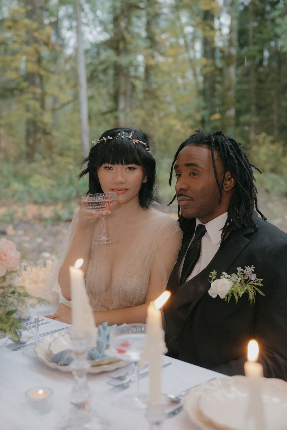 Bride and groom sitting and sharing sweet moments on their wedding table