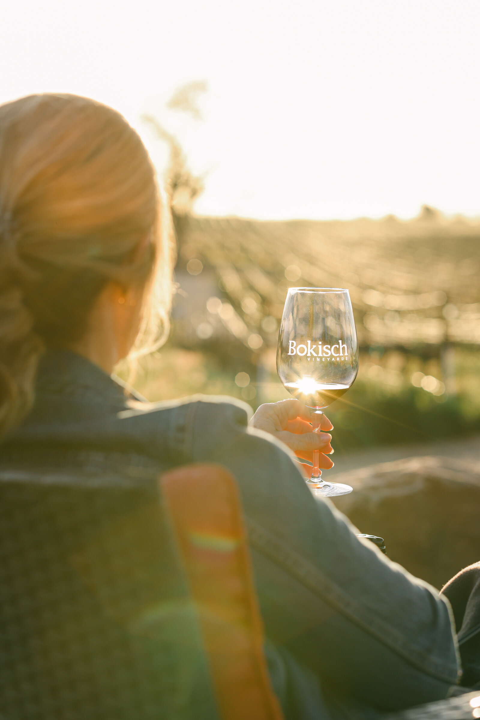 Lodi Tourism brand product photographer Chelsea Loren at Bokisch Vineyards woman with wine glass at sunset