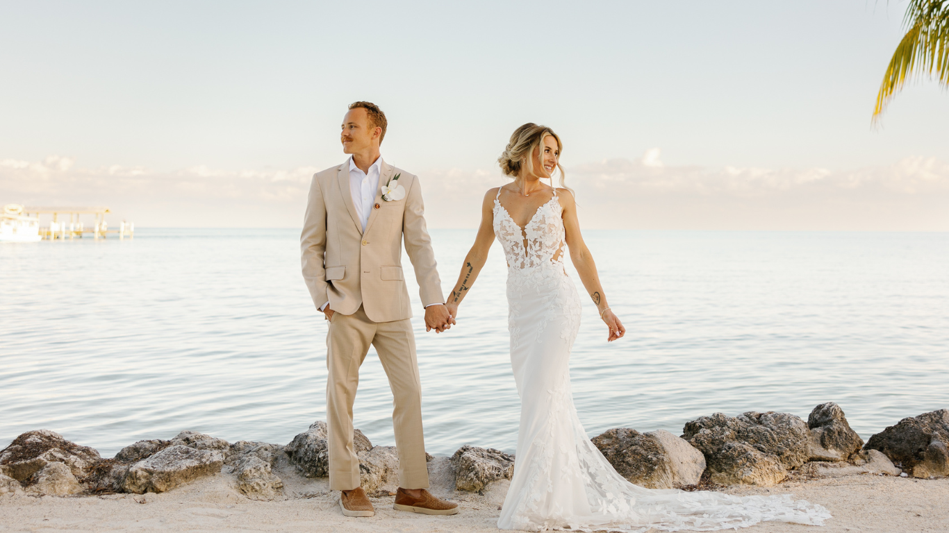 Bride and groom walking hand in hand on a serene beach at Cheeca Lodge, captured by Claudia Amalia, a wedding and lifestyle photographer based in Miami and Florida Keys, South Florida. Destination weddings available.