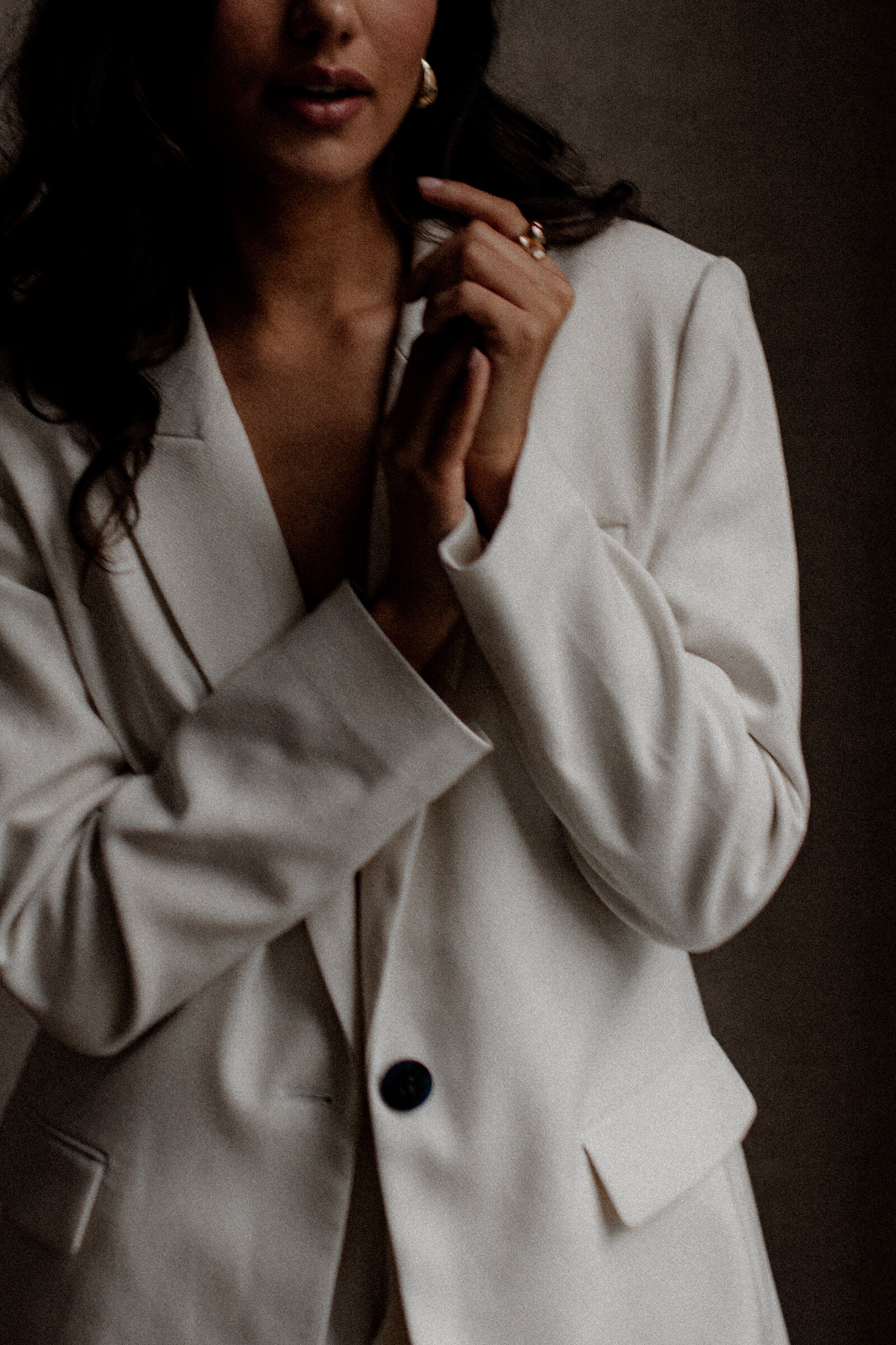 Luxury-inspired nude empowerment session with dramatic lighting and shadows.
