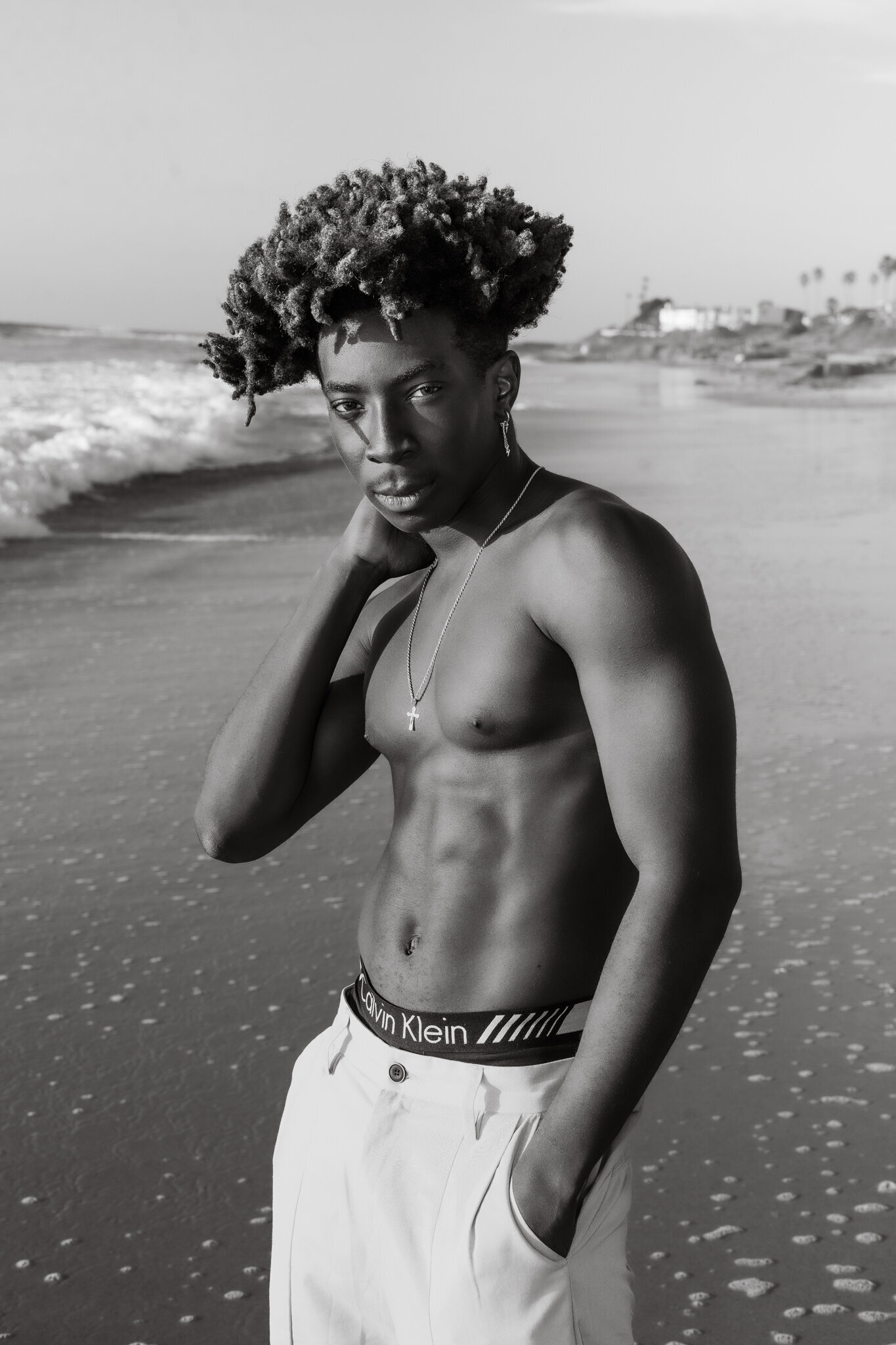 Headshot of a man shirtless with dark complexion posing in mens underwear