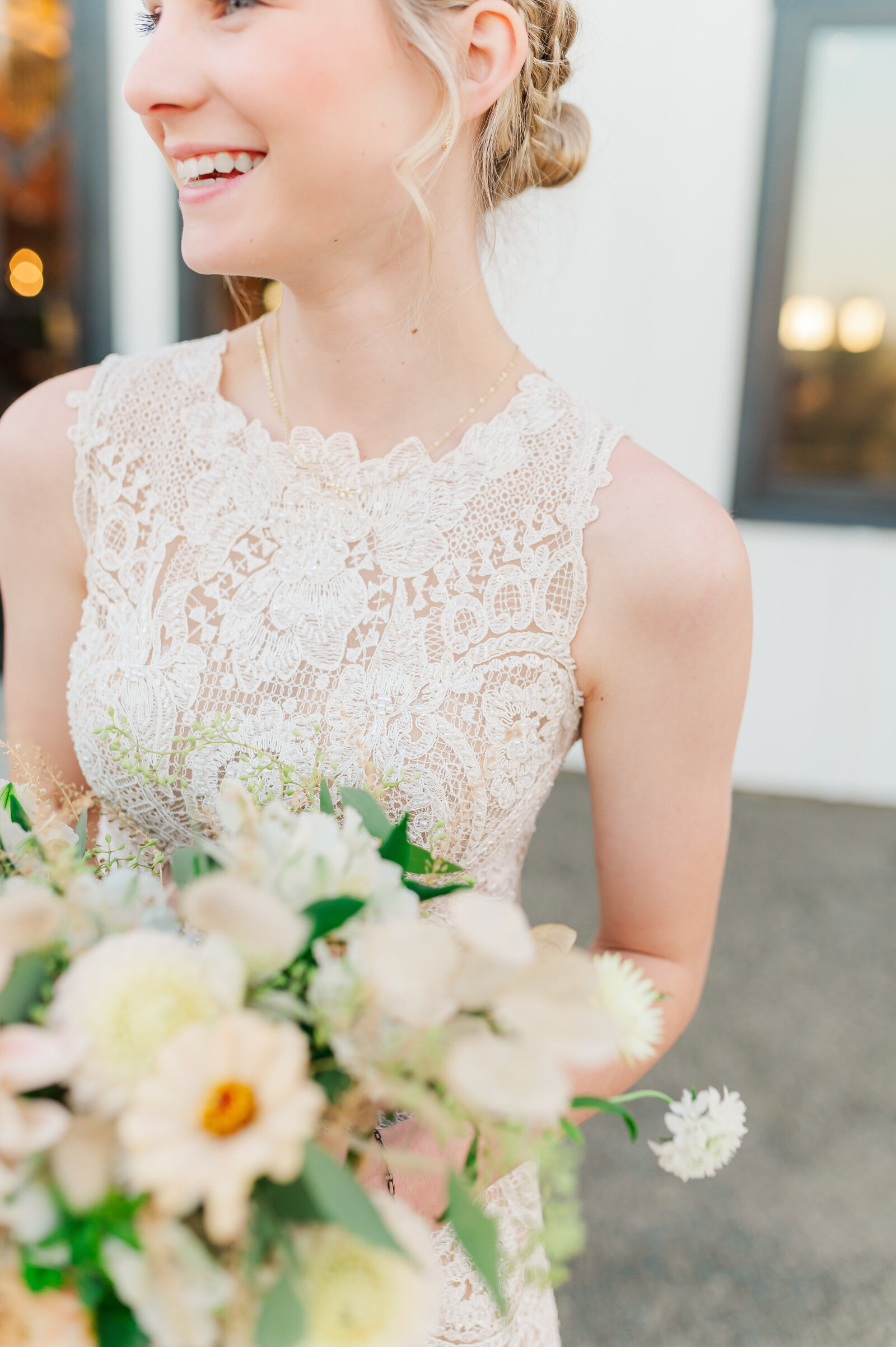 bride holding bouquet at white barn wedding venue in idahocalled edge of heaven weddings and events