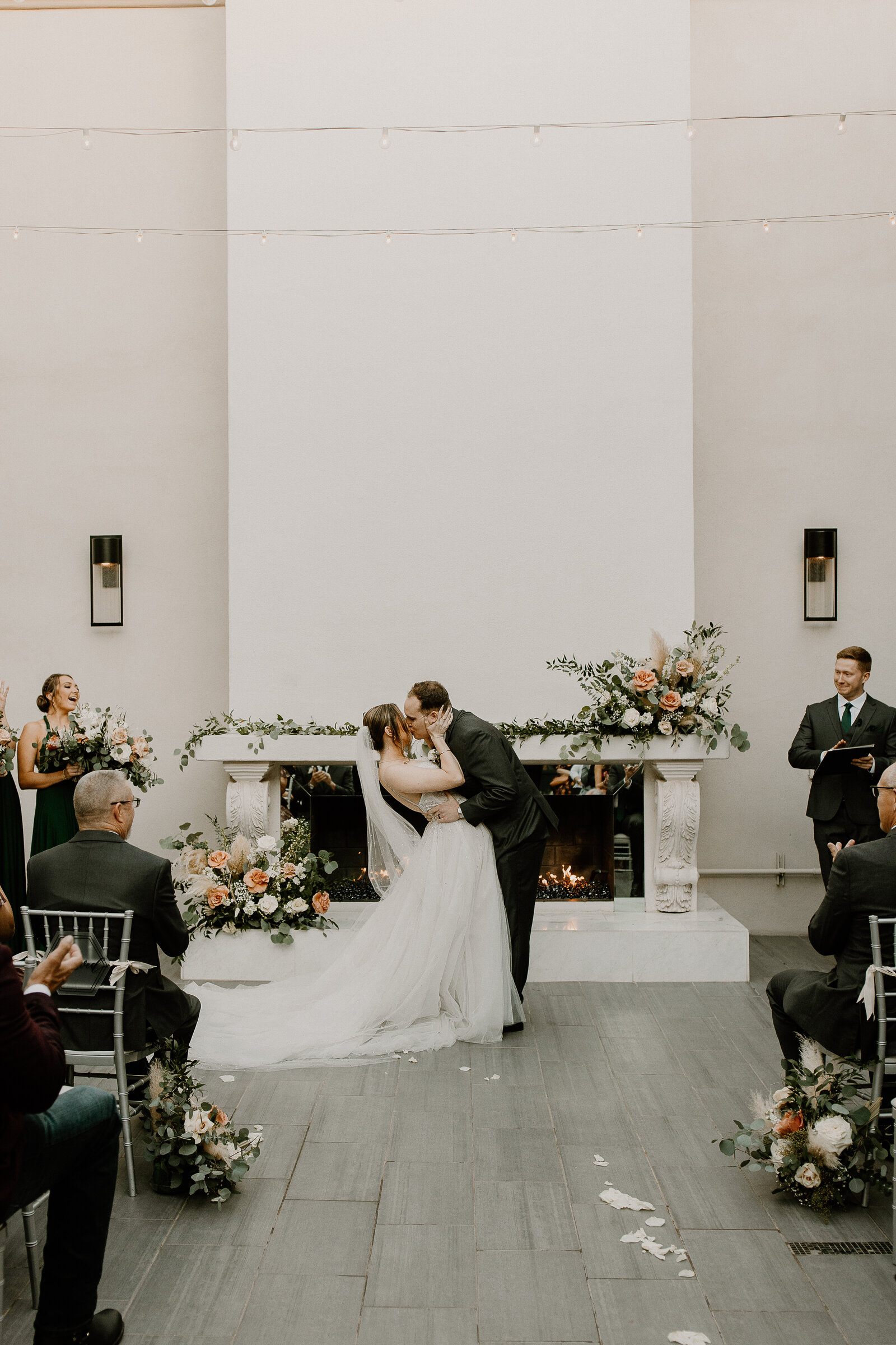 A bride and groom during their first kiss at their wedding.