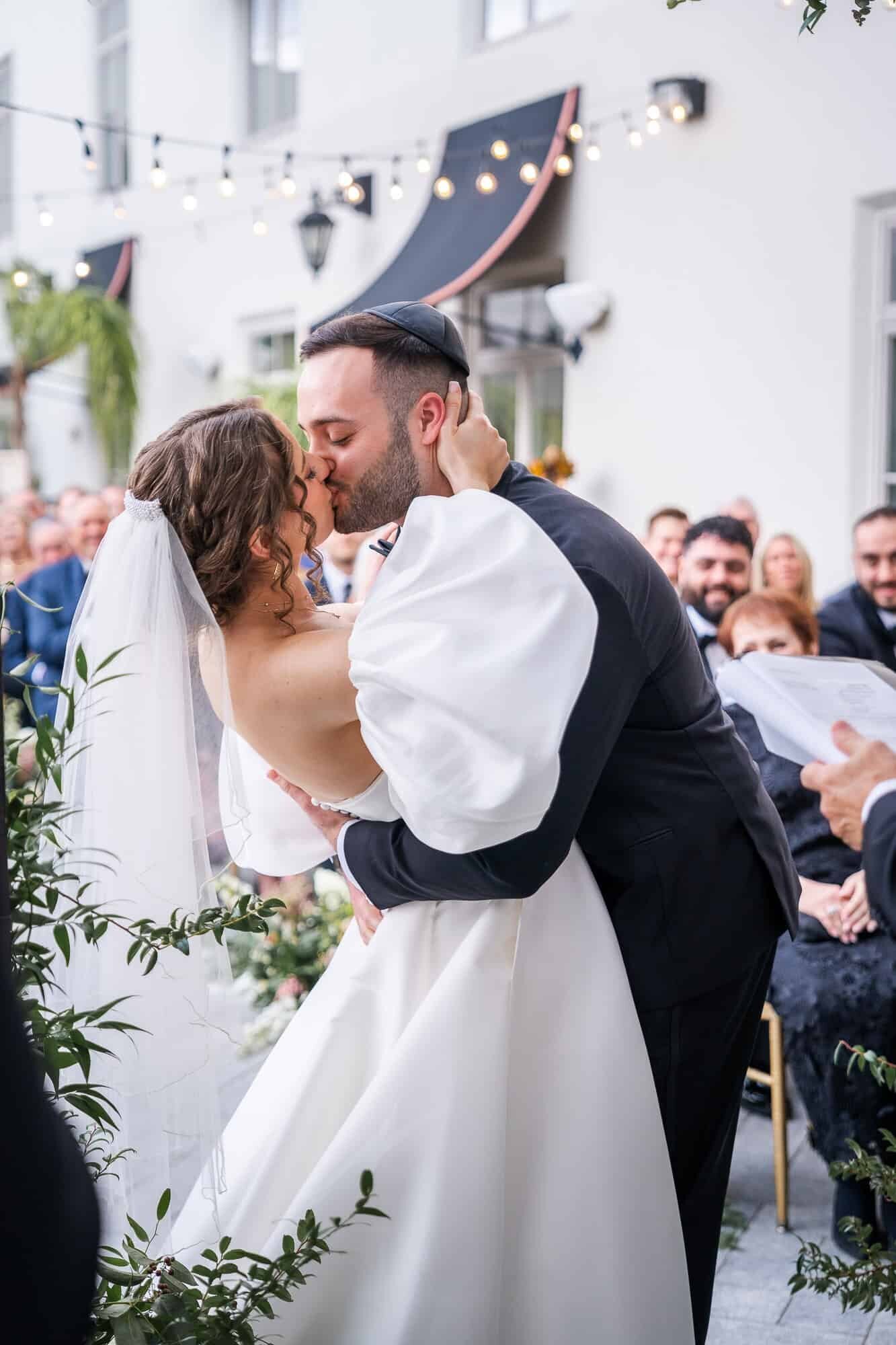 bride and groom first kiss - jewish wedding ceremony Casa Monica Wedding venue in St Augustine